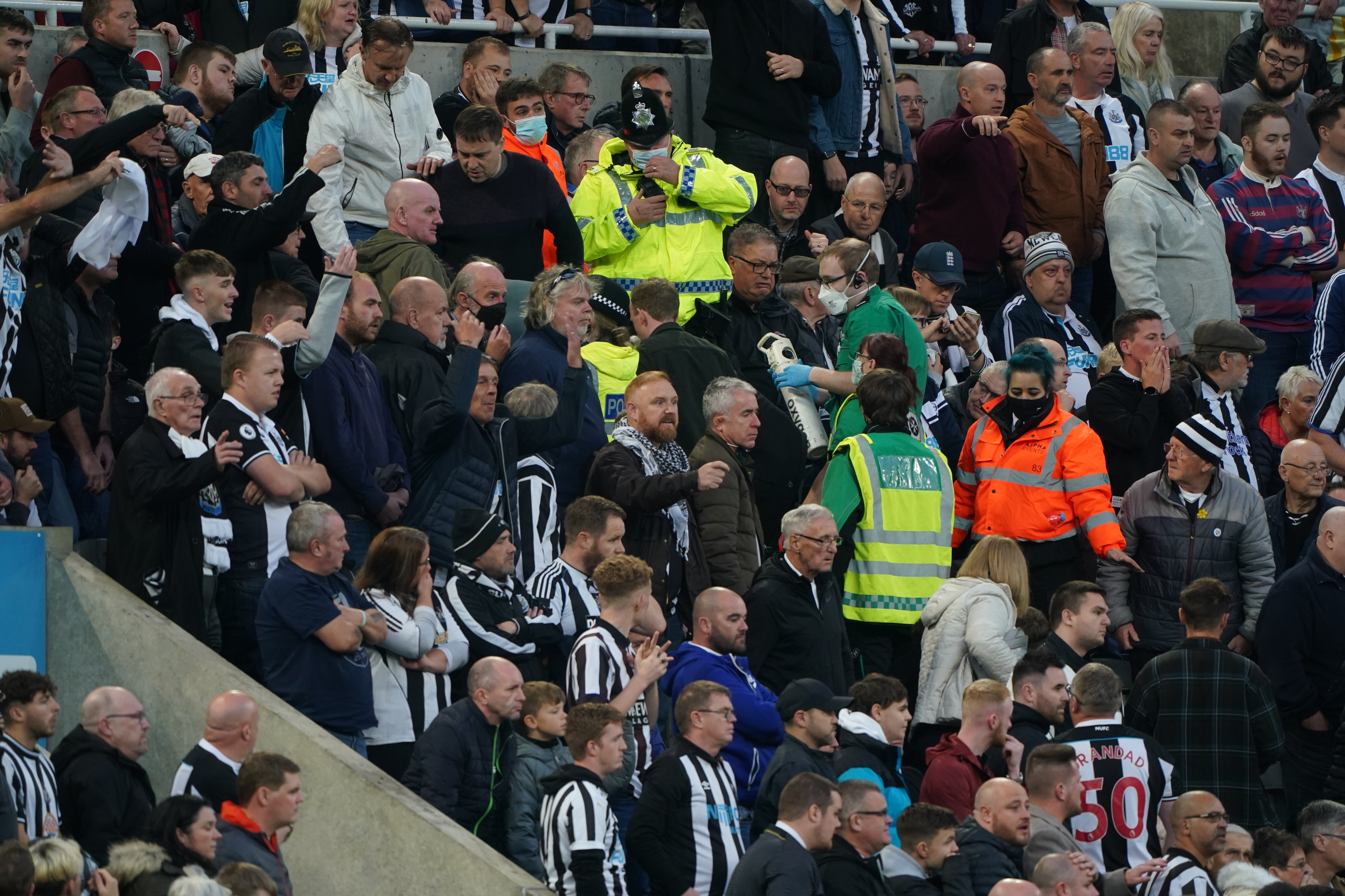 Medical personnel are called to assist a fan in the stands (Owen Humphreys/PA)