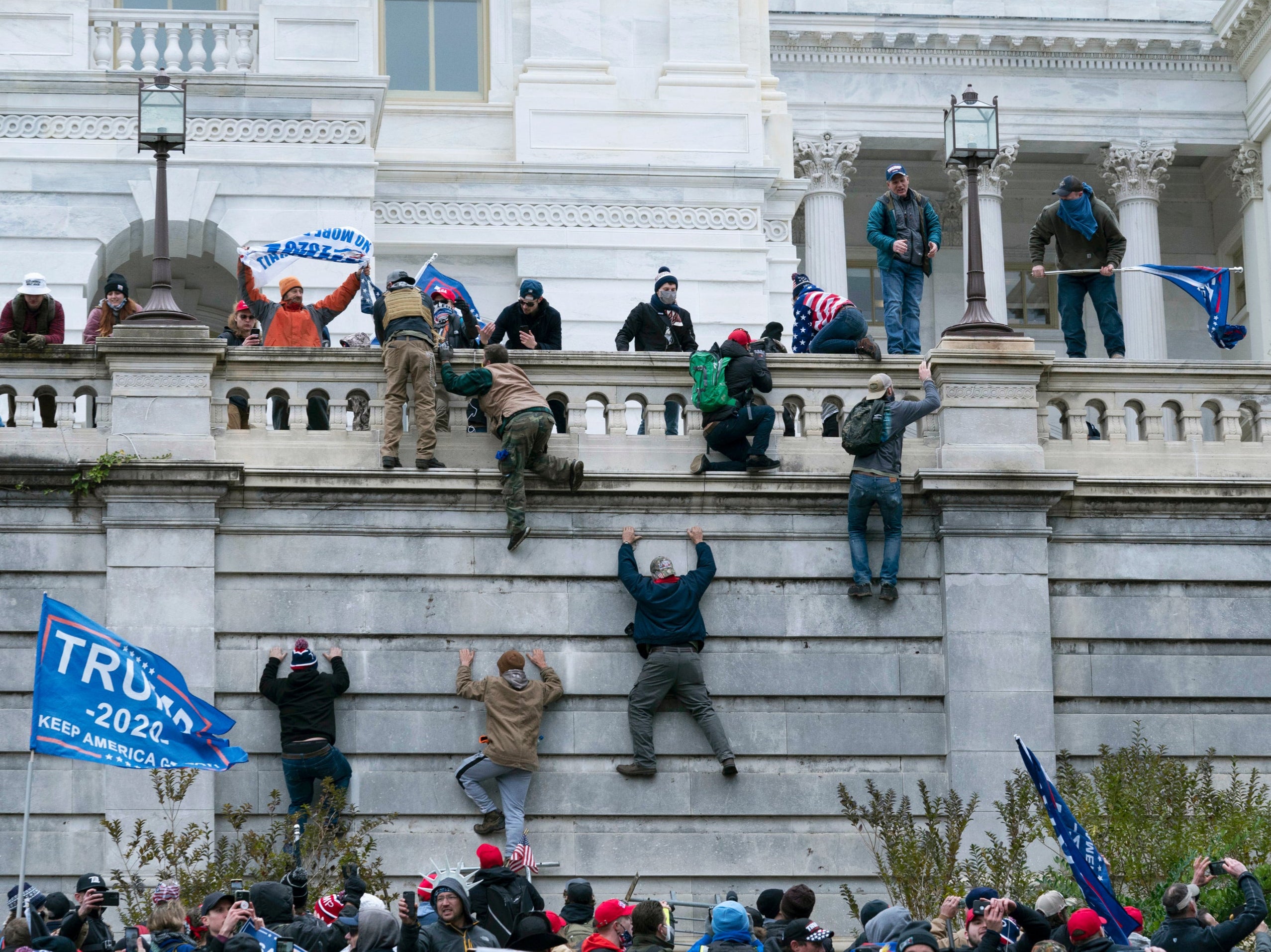 Trump supporters scale the walls of the US Capitol on 6 January 2021