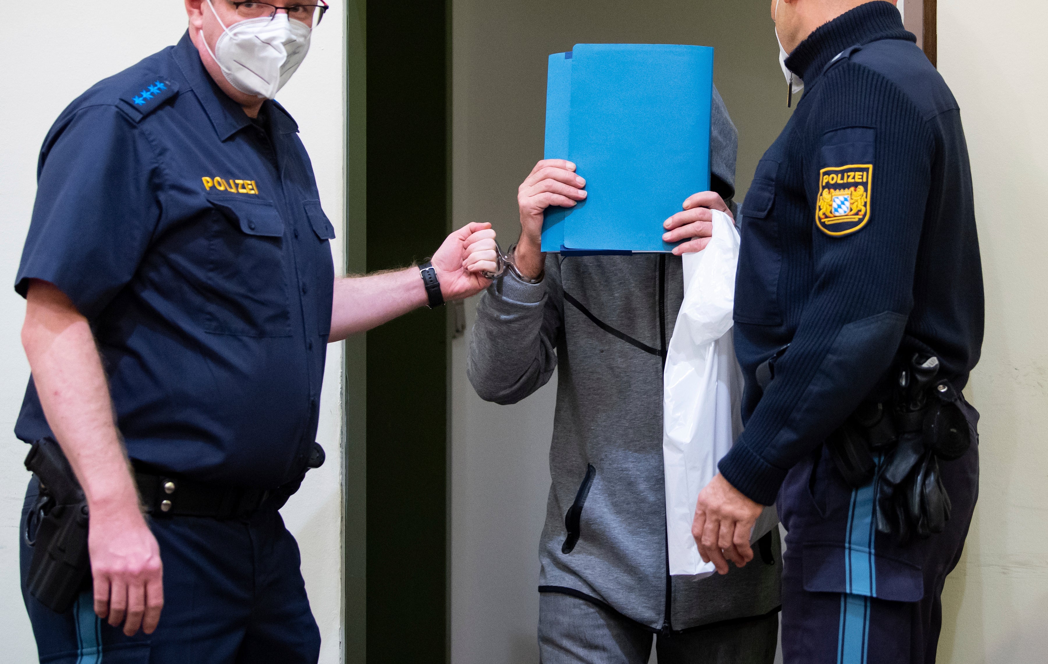 The 66-year-old accused of murder by omission arrives in the courtroom before his trial begins in Munich, Germany