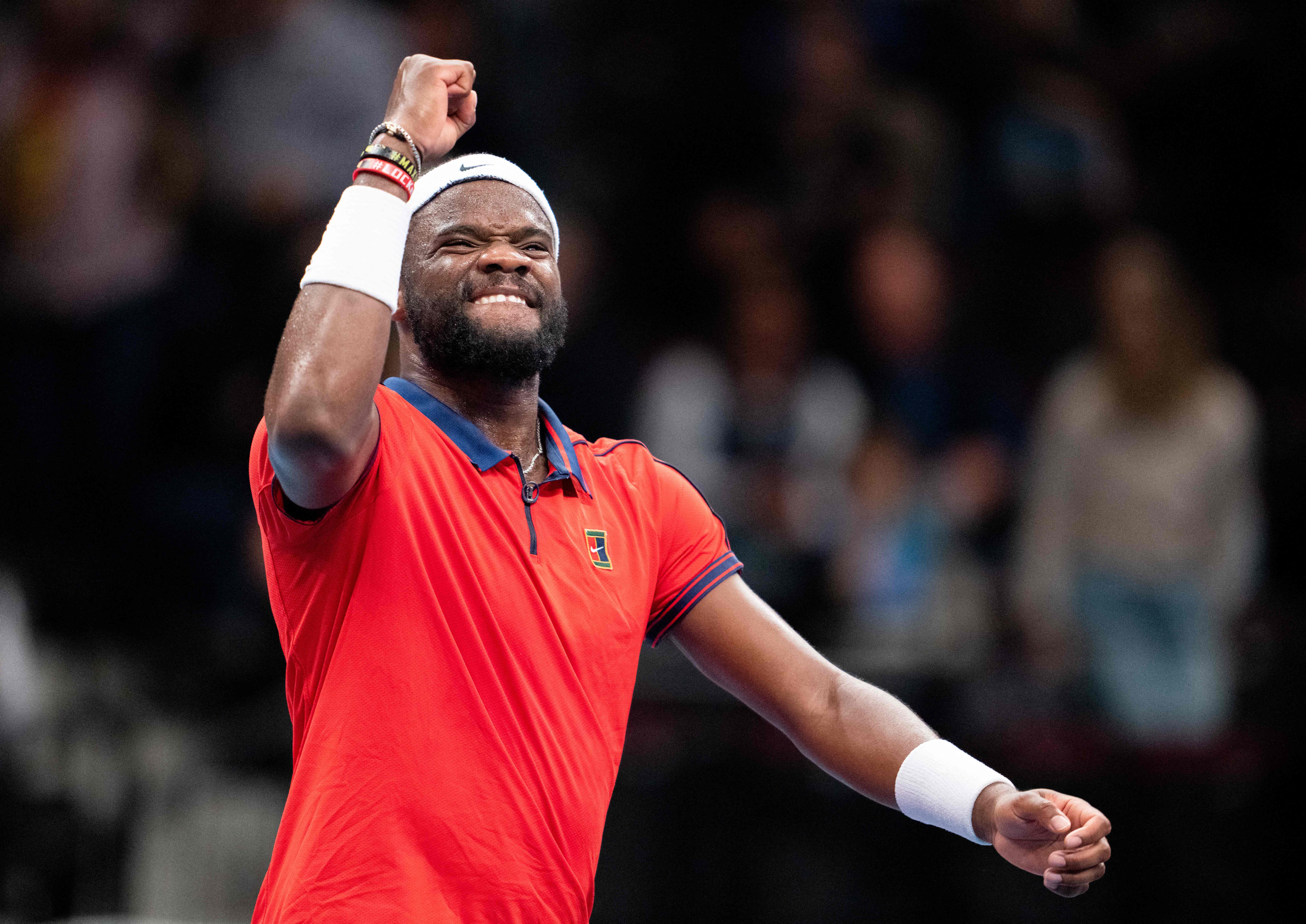Frances Tiafoe celebrates after defeating world number 3 Stefanos Tsitsipas