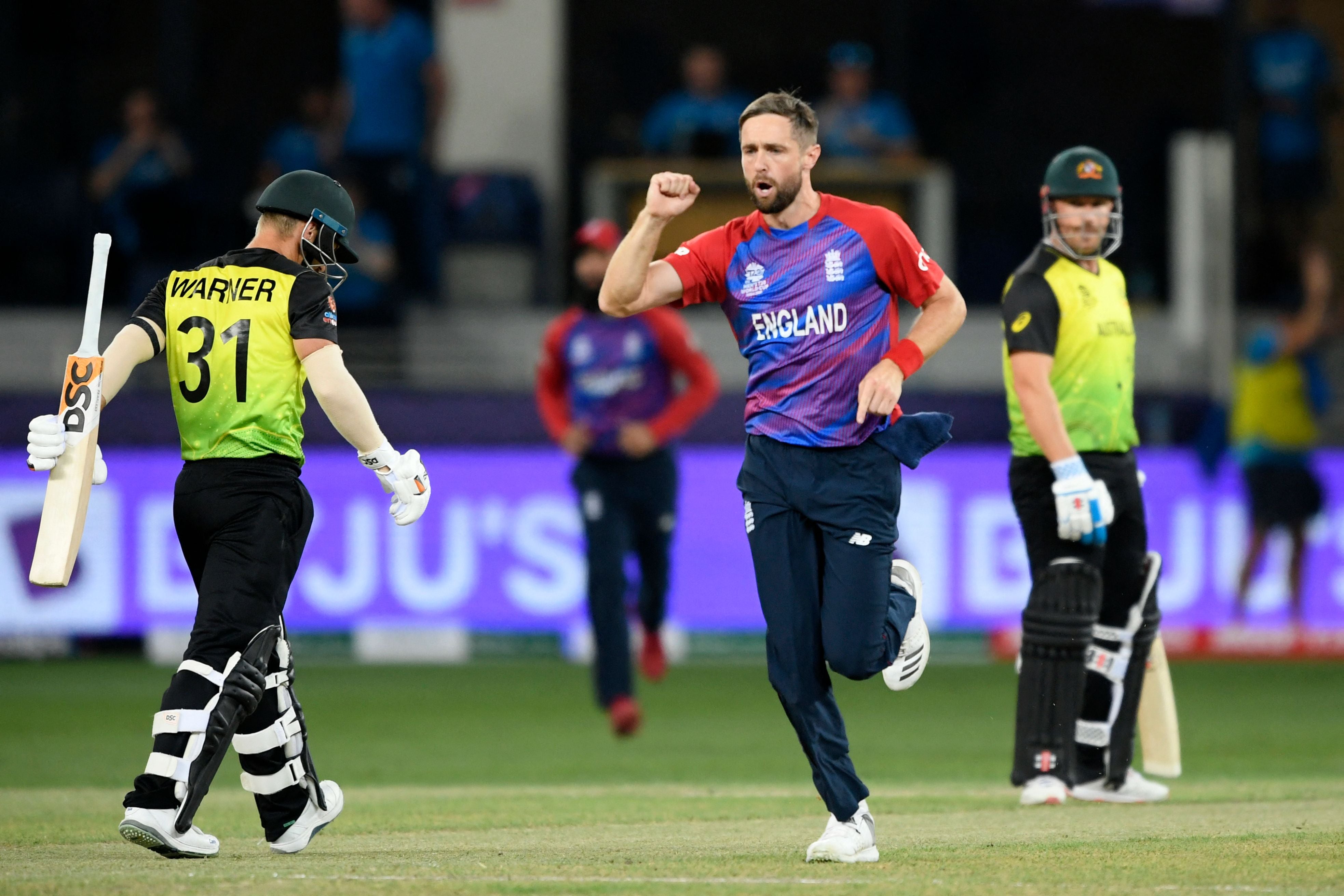 Chris Woakes celebrates the wicket of David Warner