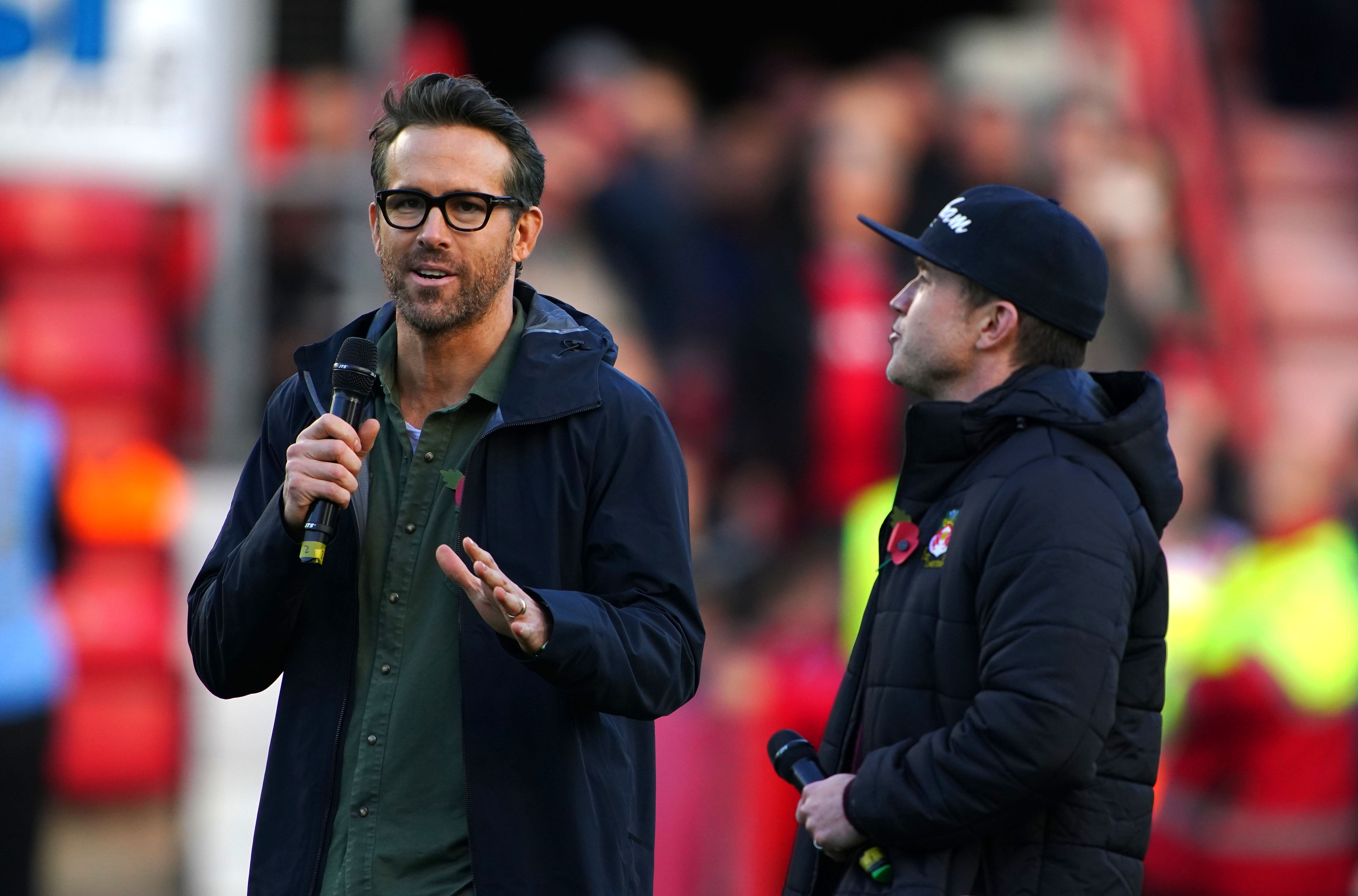 Wrexham owners Ryan Reynolds (left) and Rob McElhenney (right) speak to the crowd before the 1-1 Vanarama National League match with Torquay (Peter Byrne/PA)