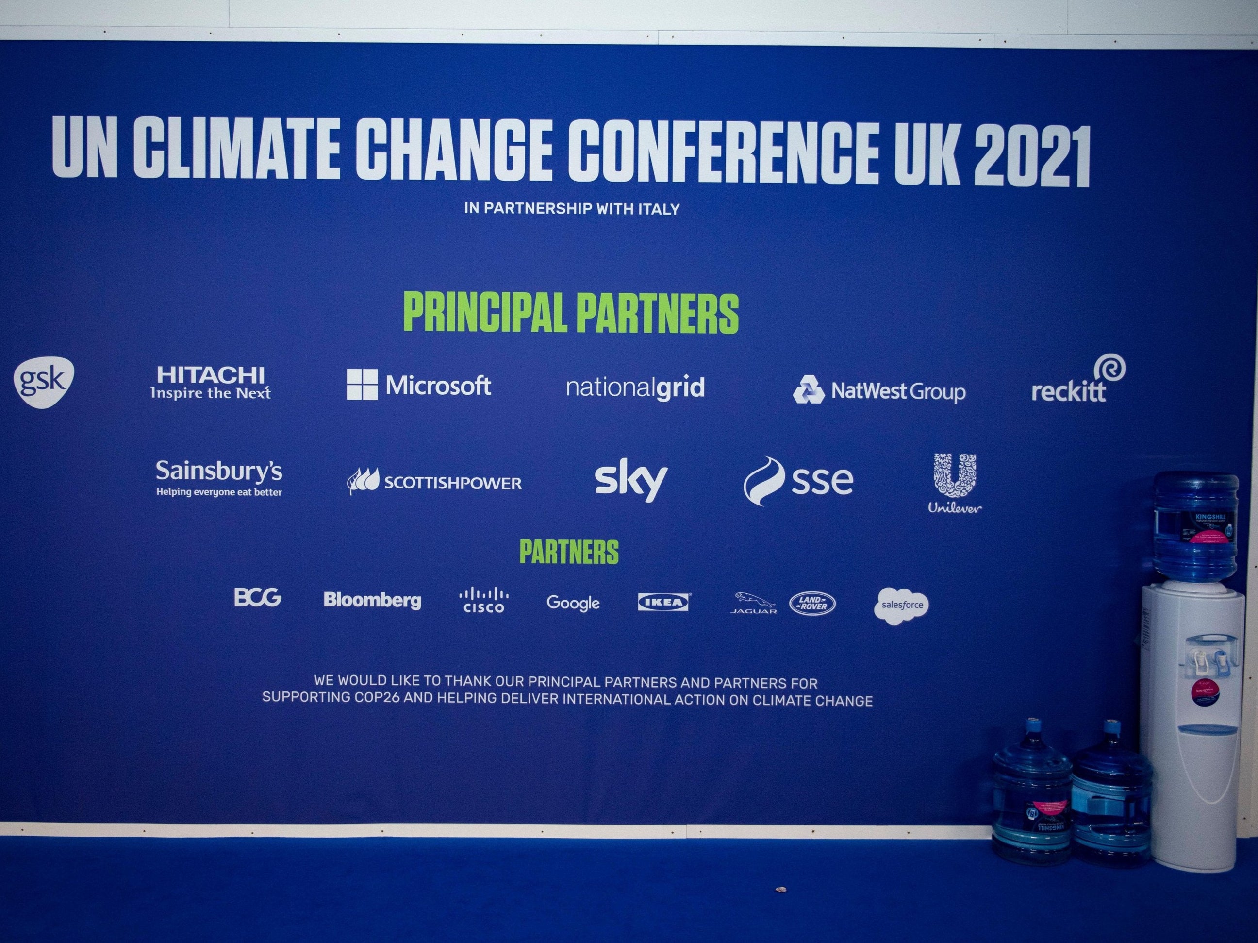 The sponsors’ names emblazoned across the Cop26 venue’s wall