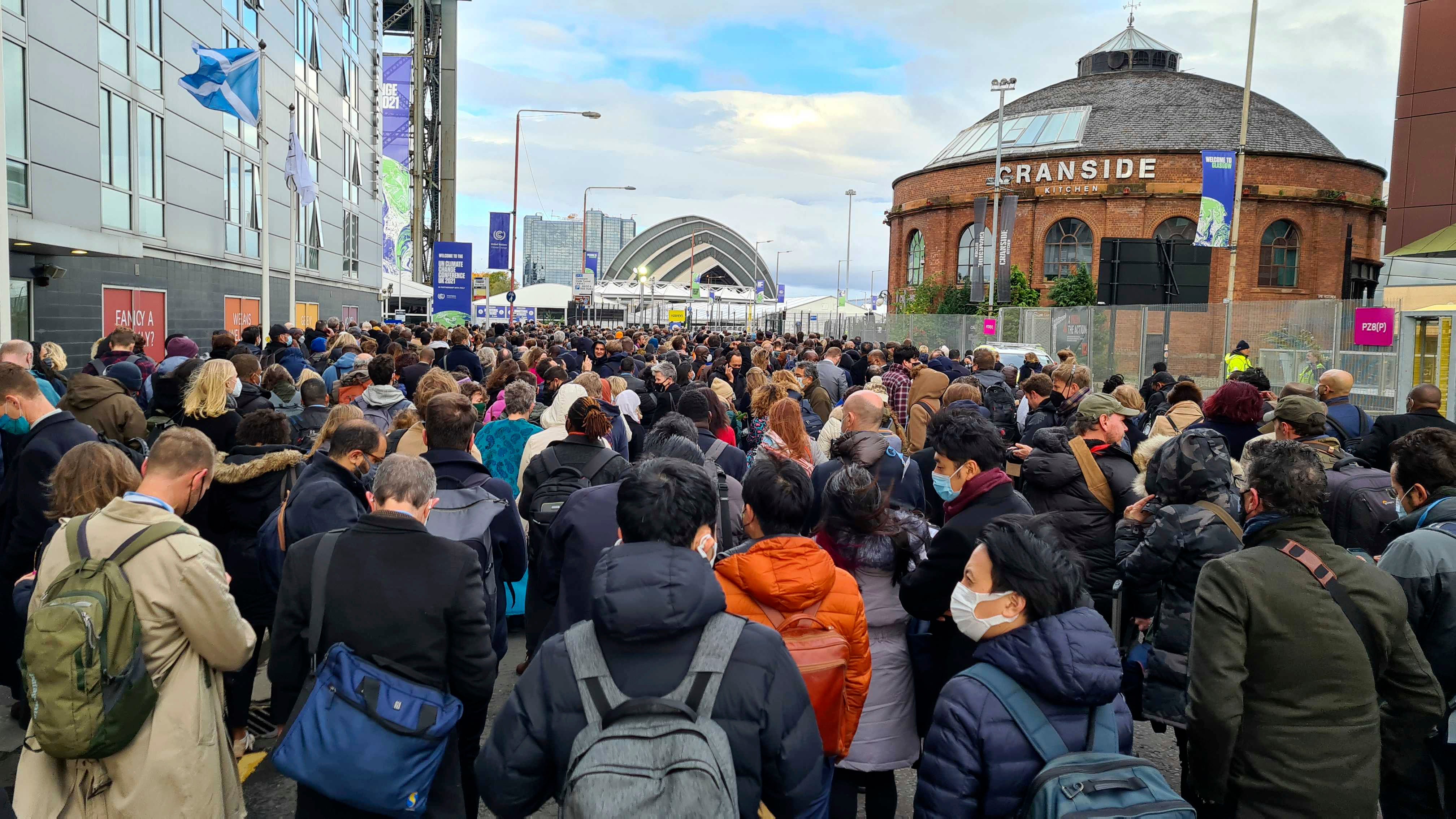 Densely packed crowds wait to be let in to the Cop26 climate summit on Monday