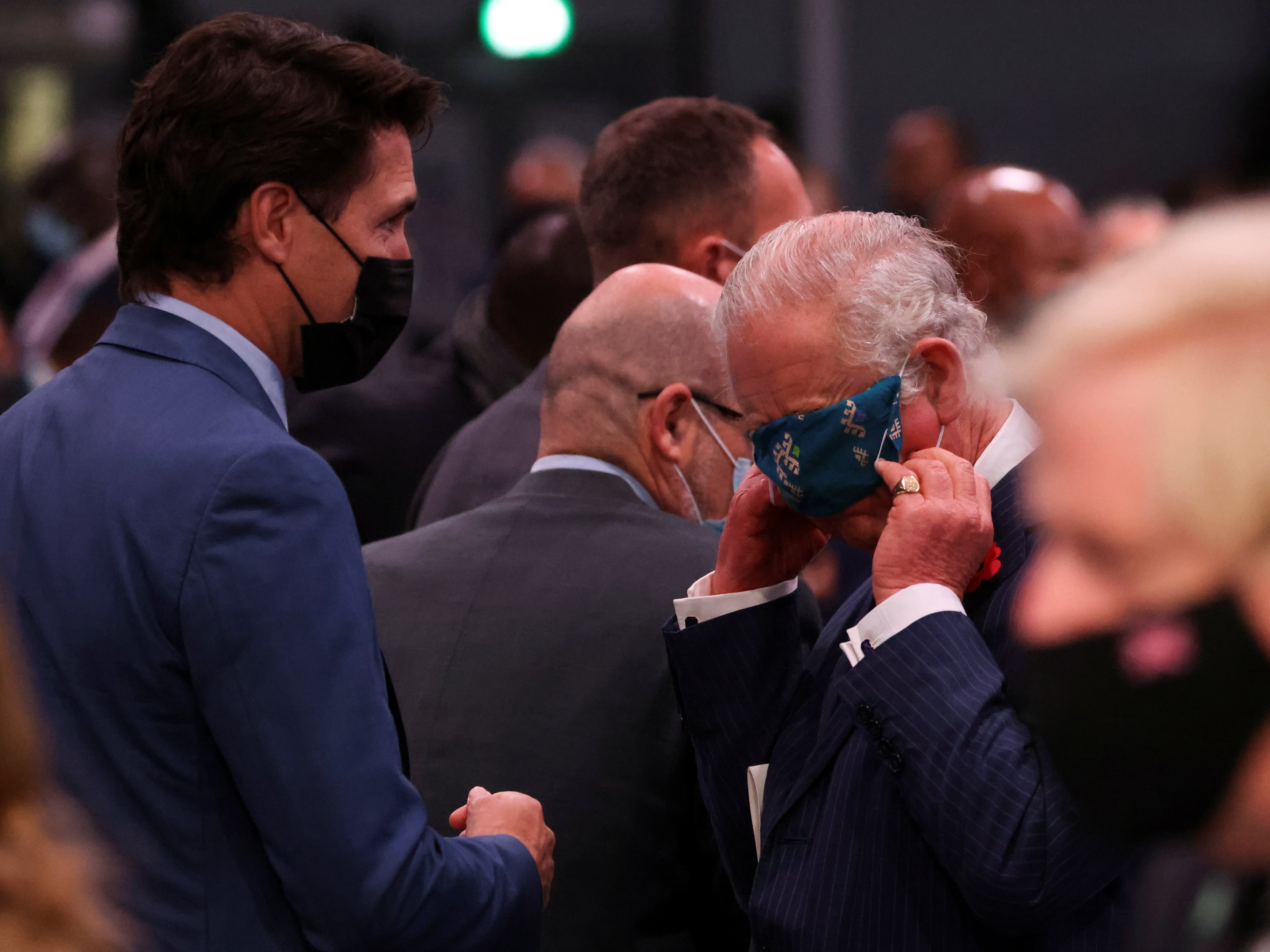 The Prince of Wales adjusts his face mask next to Justin Trudeau, Canada’s prime minister, at the Cop26 opening ceremony