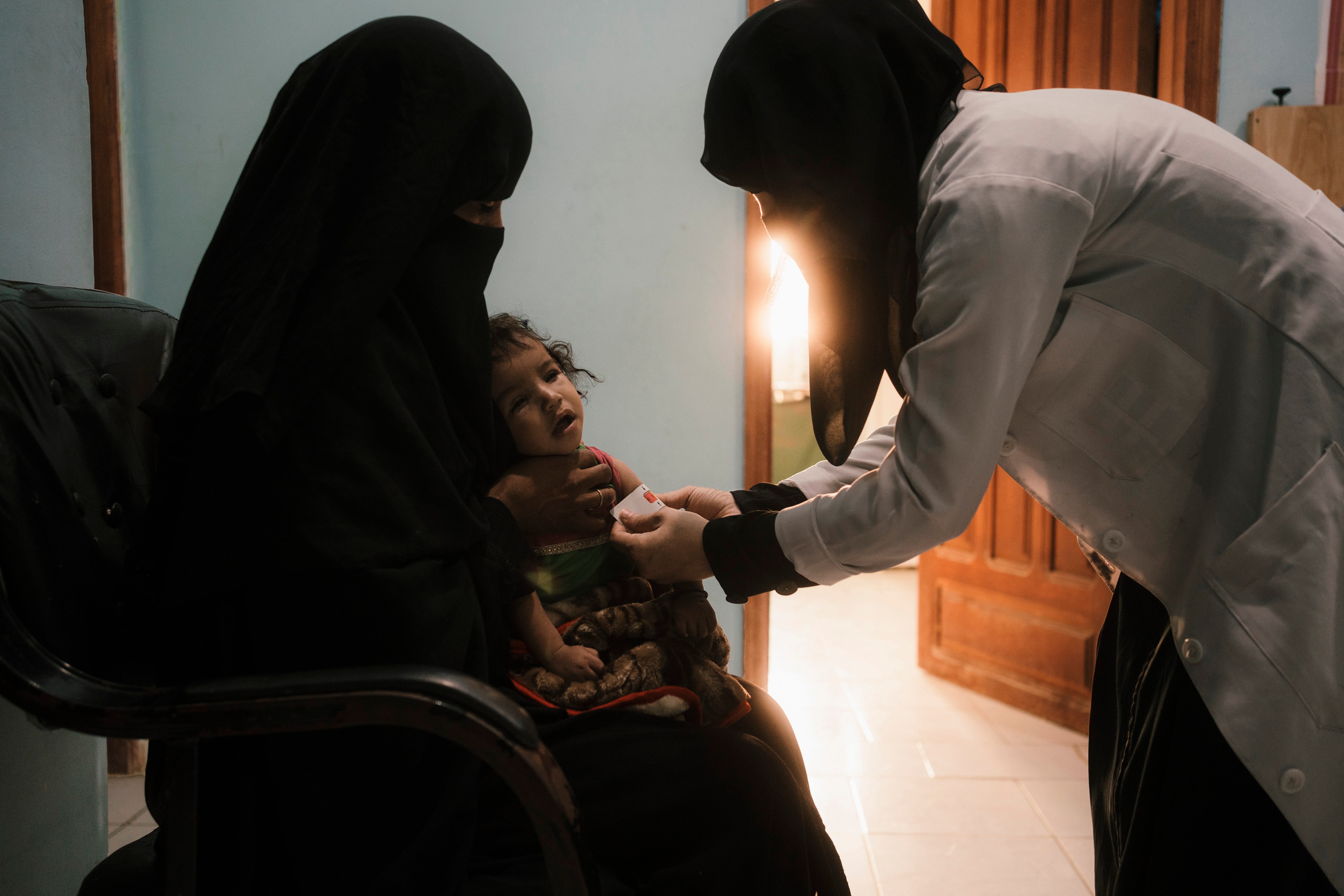 Bushra Ali Sagheer Surban gets treatment for Reena at a hospital in Hajjah city