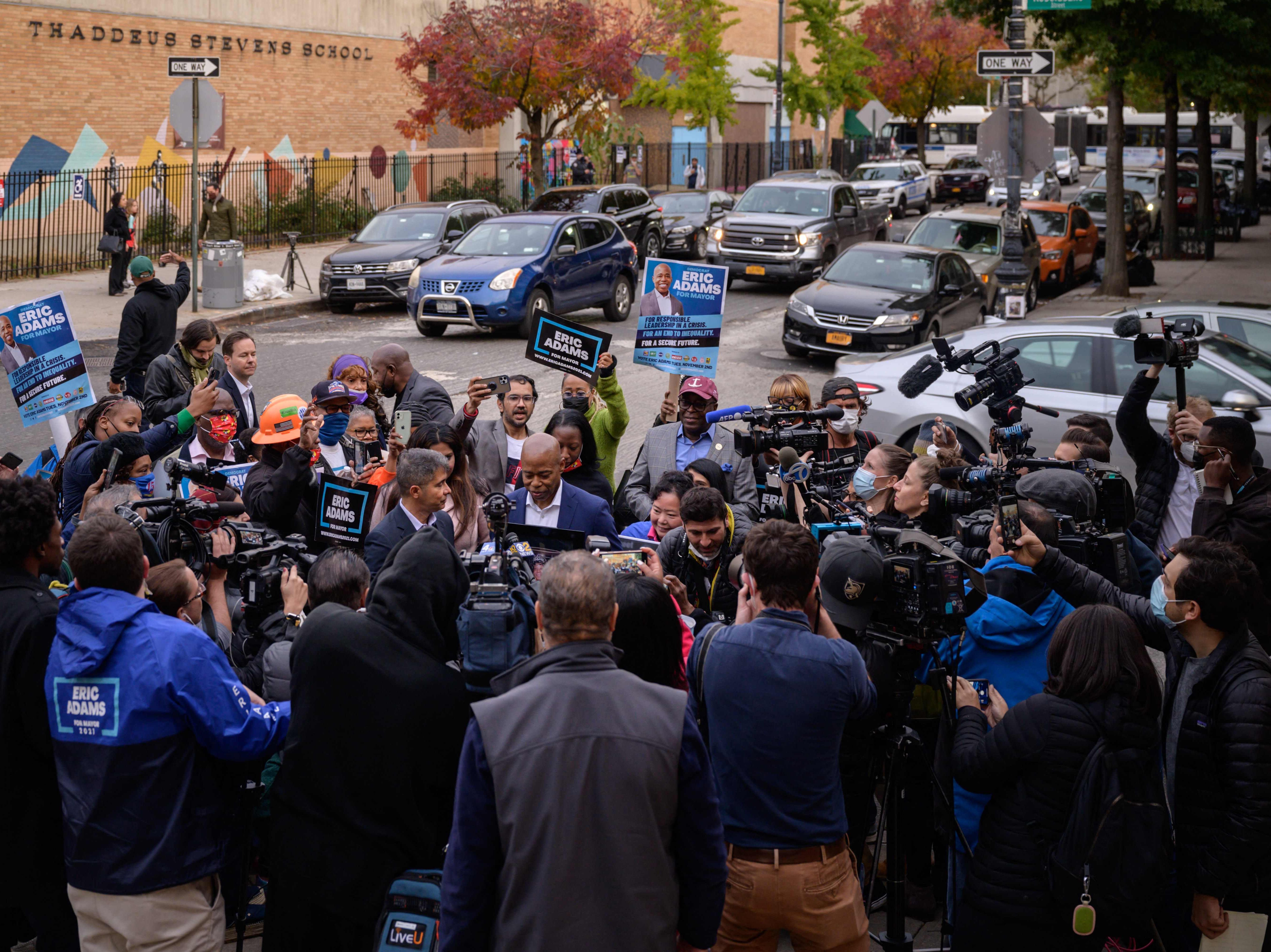 New York democratic mayoral candidate Eric Adams (C) speaks to supporters and the media upon leaving a voting center after casting his ballot, in Brooklyn, New York on Novembver 2, 2021