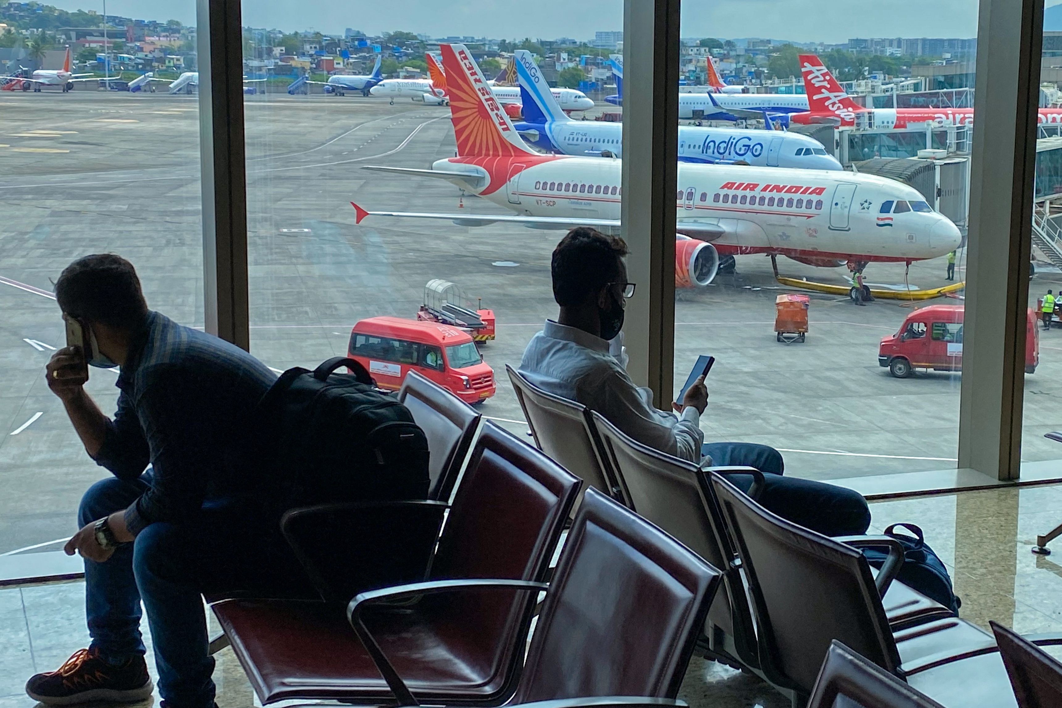 An Air India aircraft is pictured at a terminal of the airport in Mumbai on October 9, 2021. Experts say India is seeing is nothing but pent-up demand in travel.