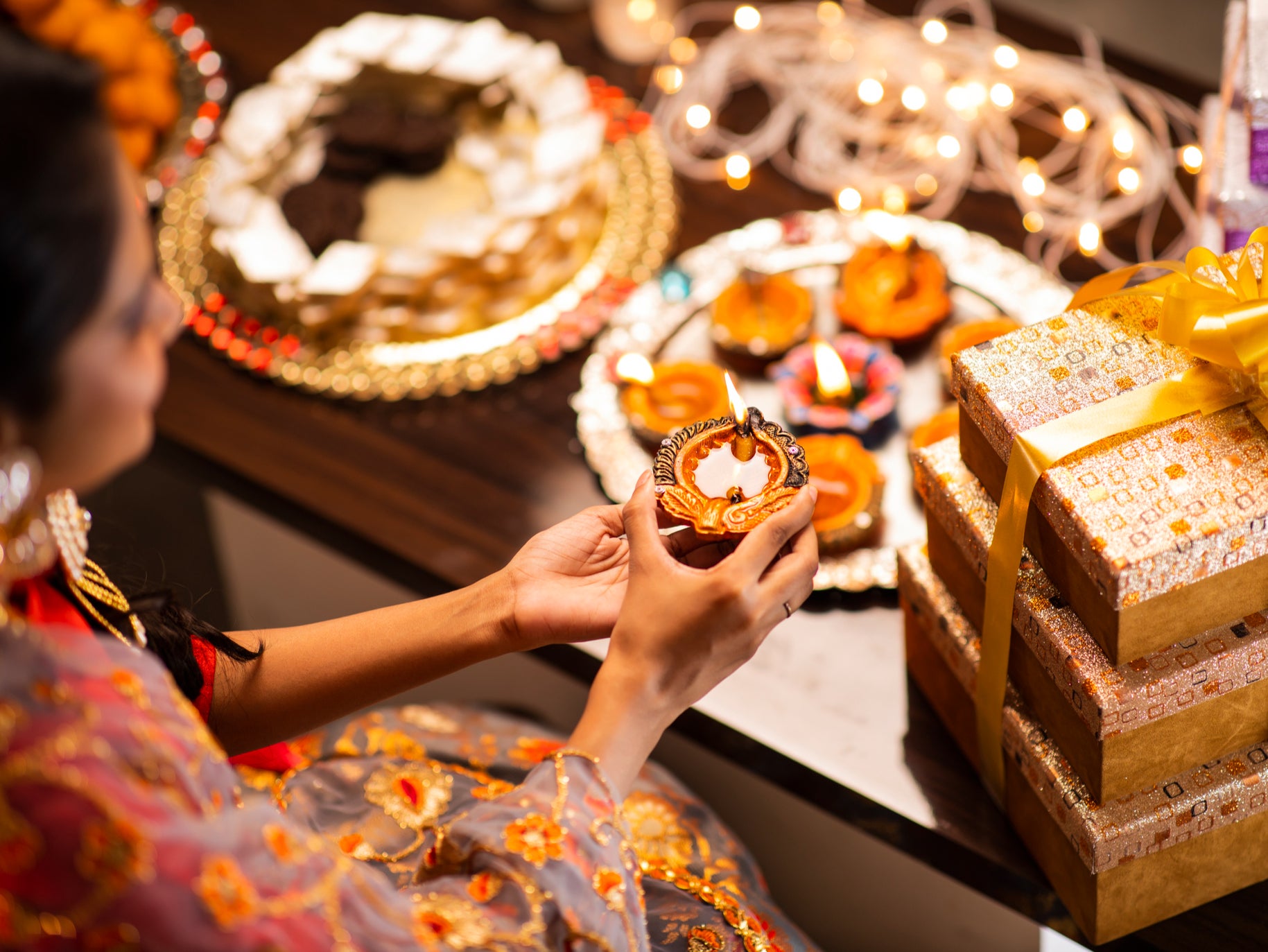 A woman arranges Diwali lights