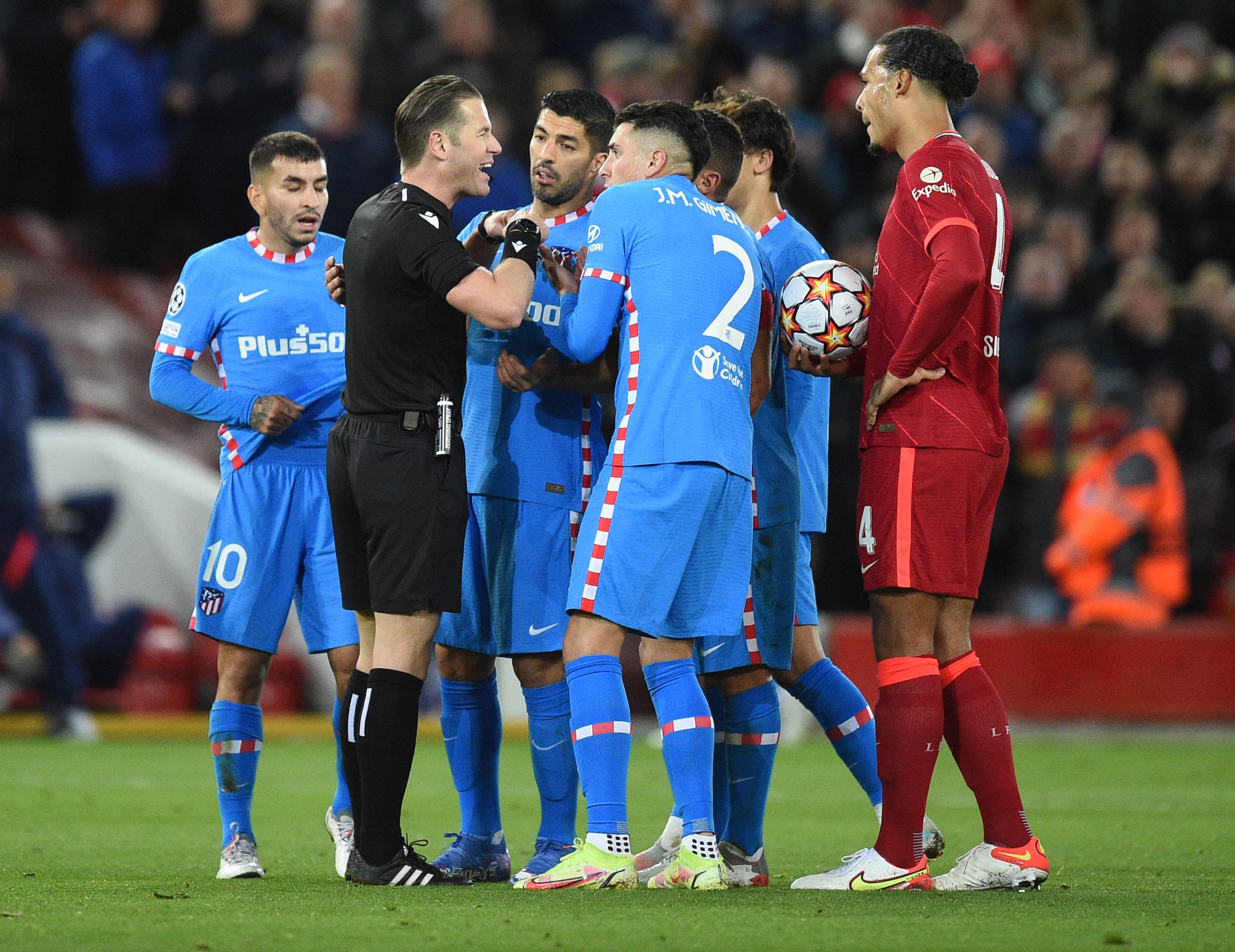 Atletico players protest the sending-off of Felipe