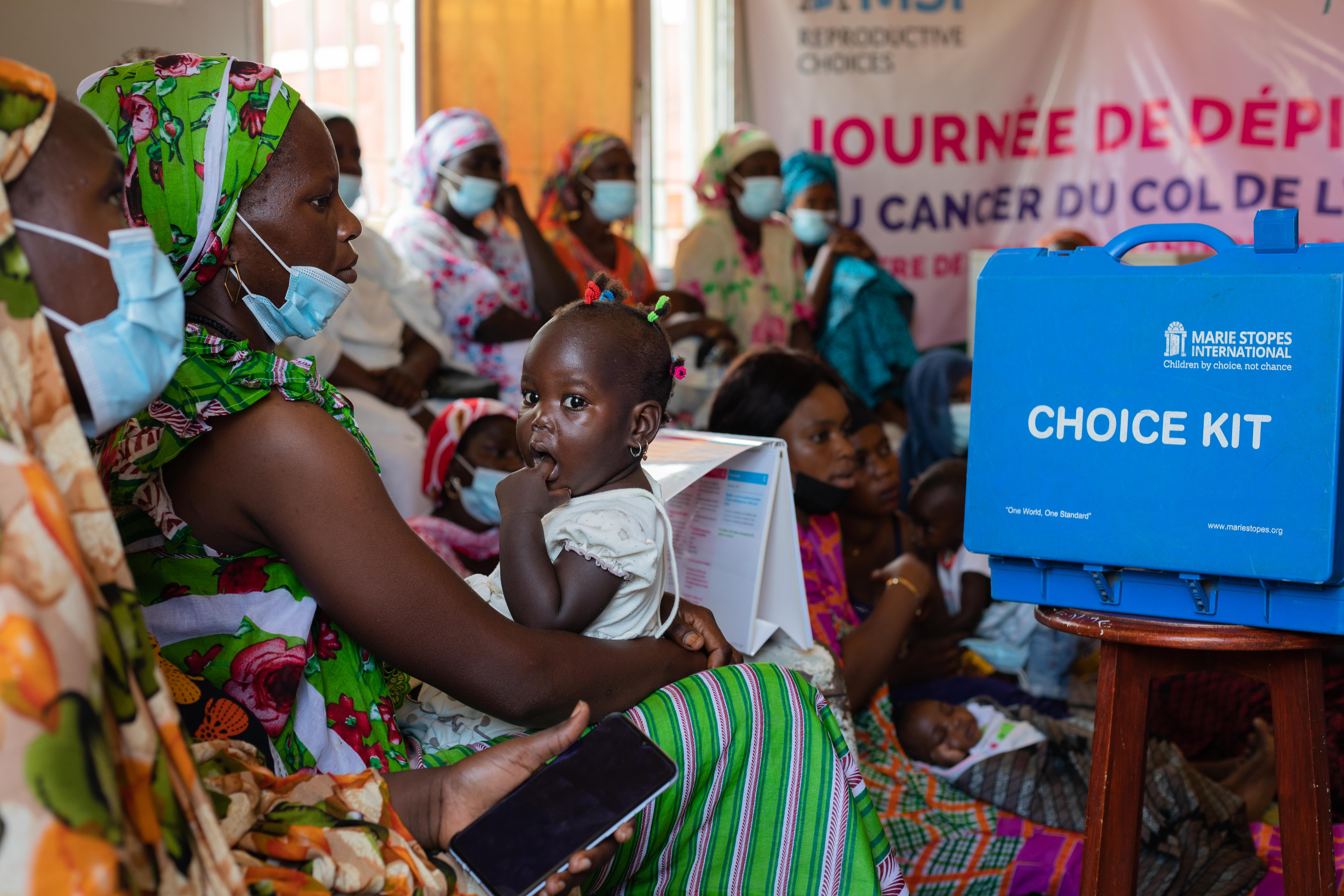 Mother and child attend a service delivery day in Joal-Fadiouth. The Mbour Outreach team at MSI runs around 14 of these days per month