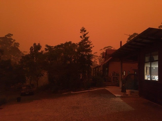 Jo Dodds’ house is shrouded in darkness in the middle of the day as bushfires rage nearby