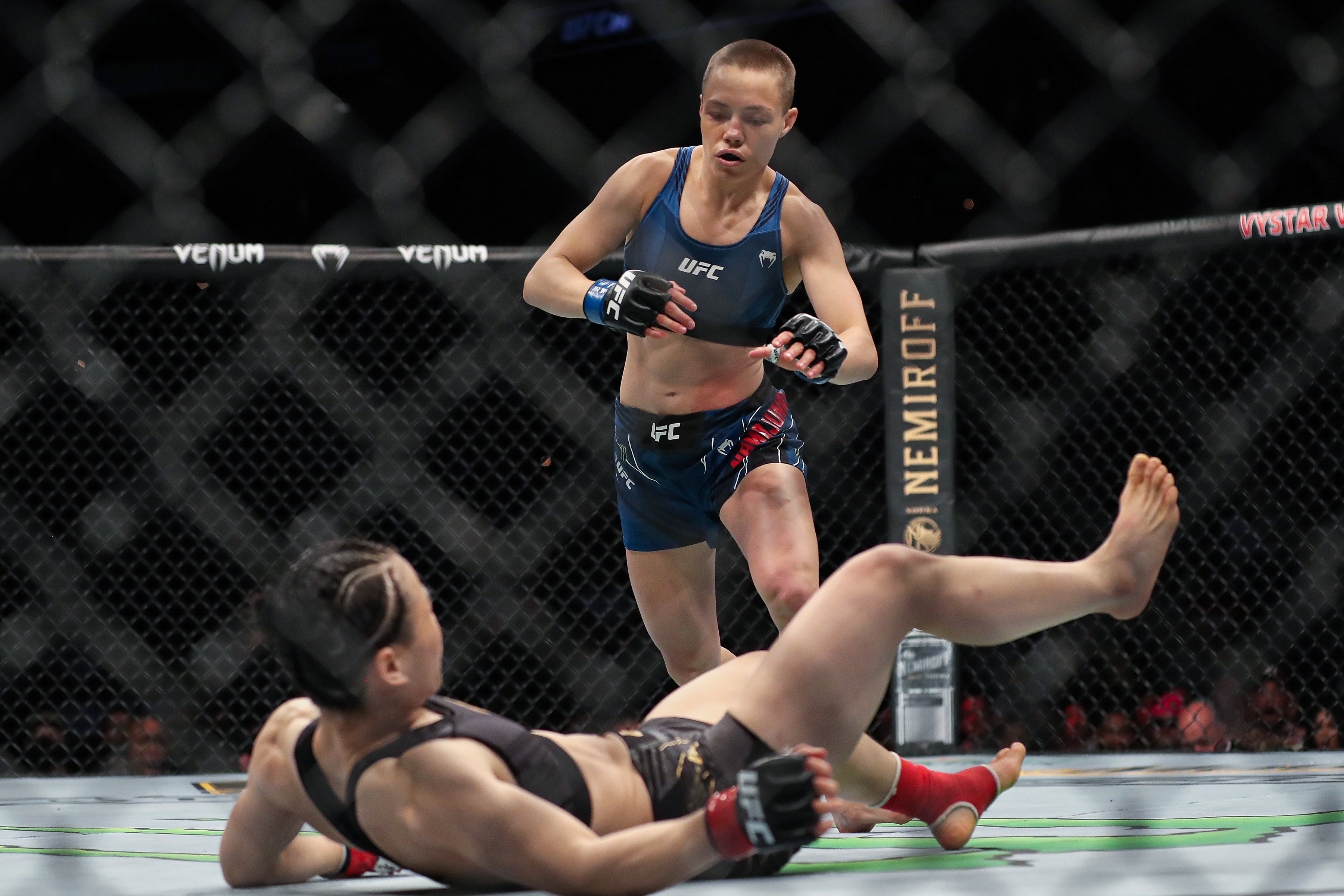 Rose Namajunas (top) finished Weili Zhang with a head kick earlier this year