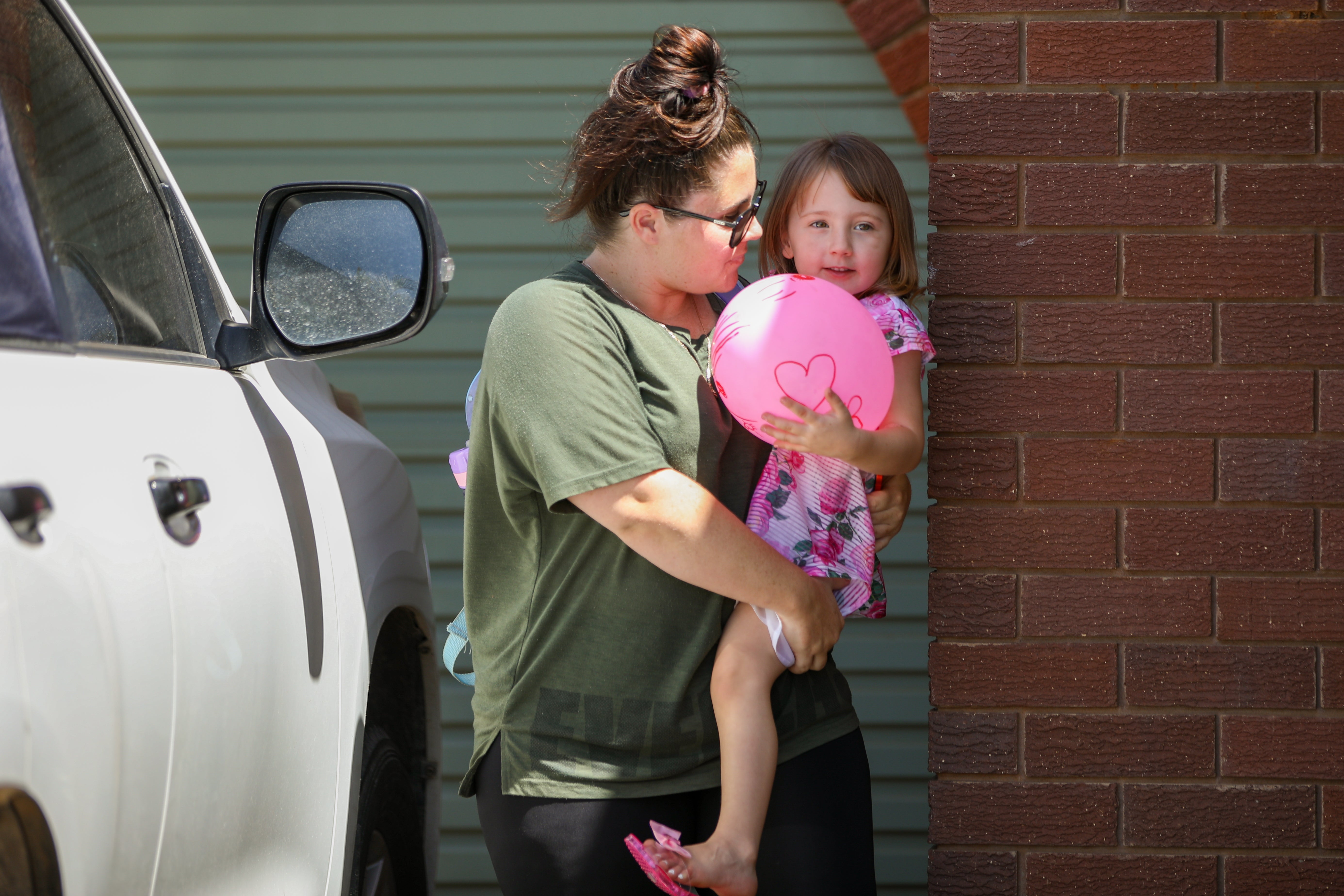 Cleo Smith is carried inside a friend's house by her mother on 4 November 2021 in Carnarvon, Australia