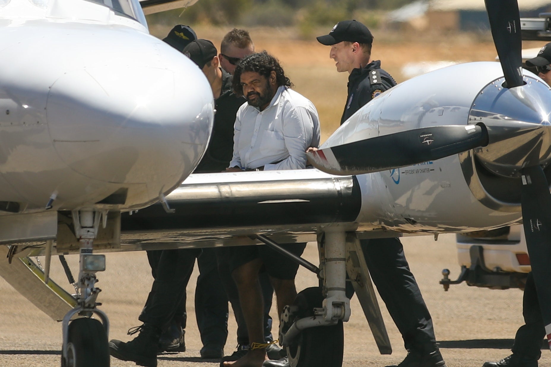 Terence Darrell Kelly boards a plane after being taken into custody by members of the Special Operations Group at Carnarvon airport on 5 November 2021 in Carnarvon , Australia