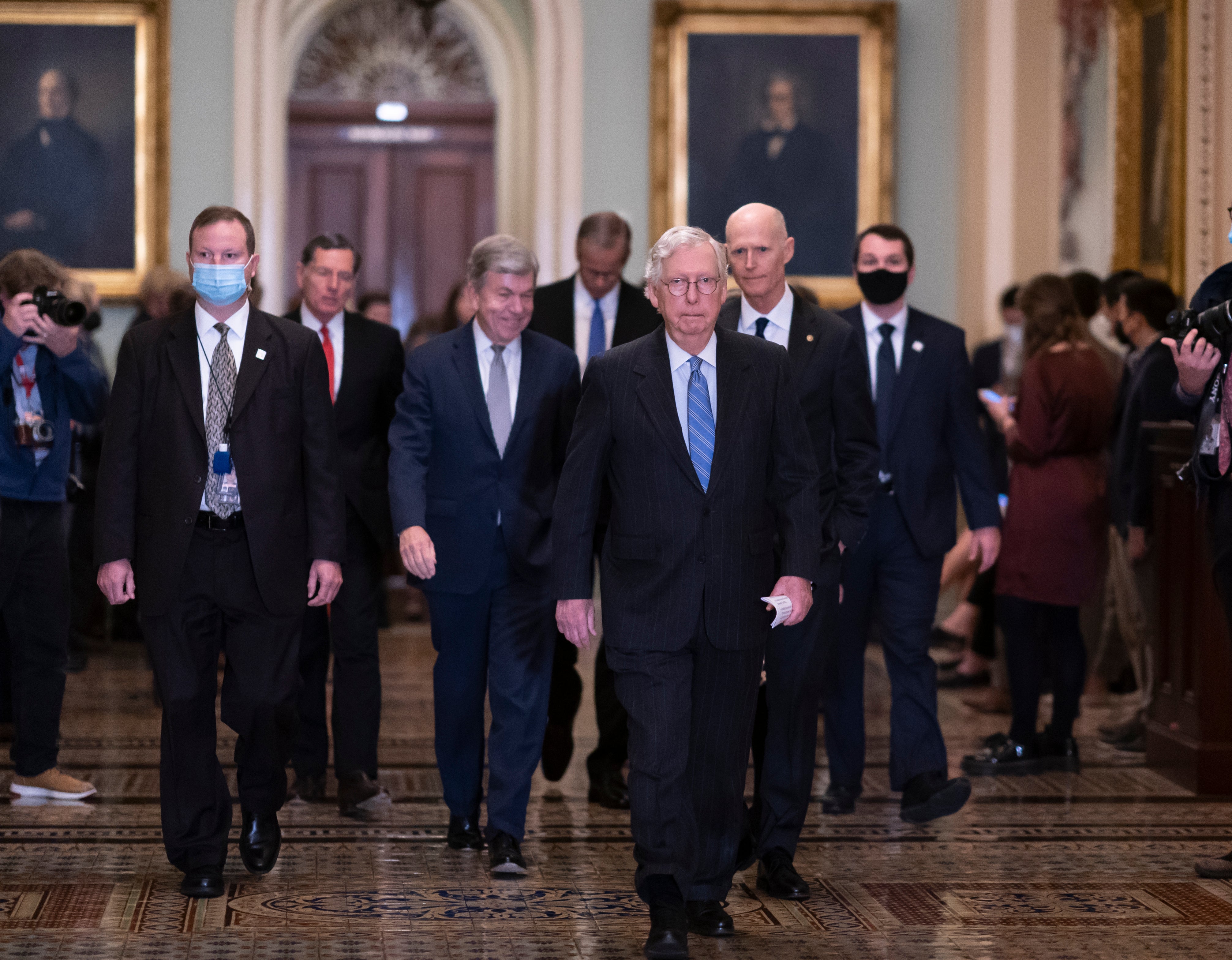 Senate minority leader Mitch McConnell leads his fellow Republicans after a GOP policy meeting at the US Capitol