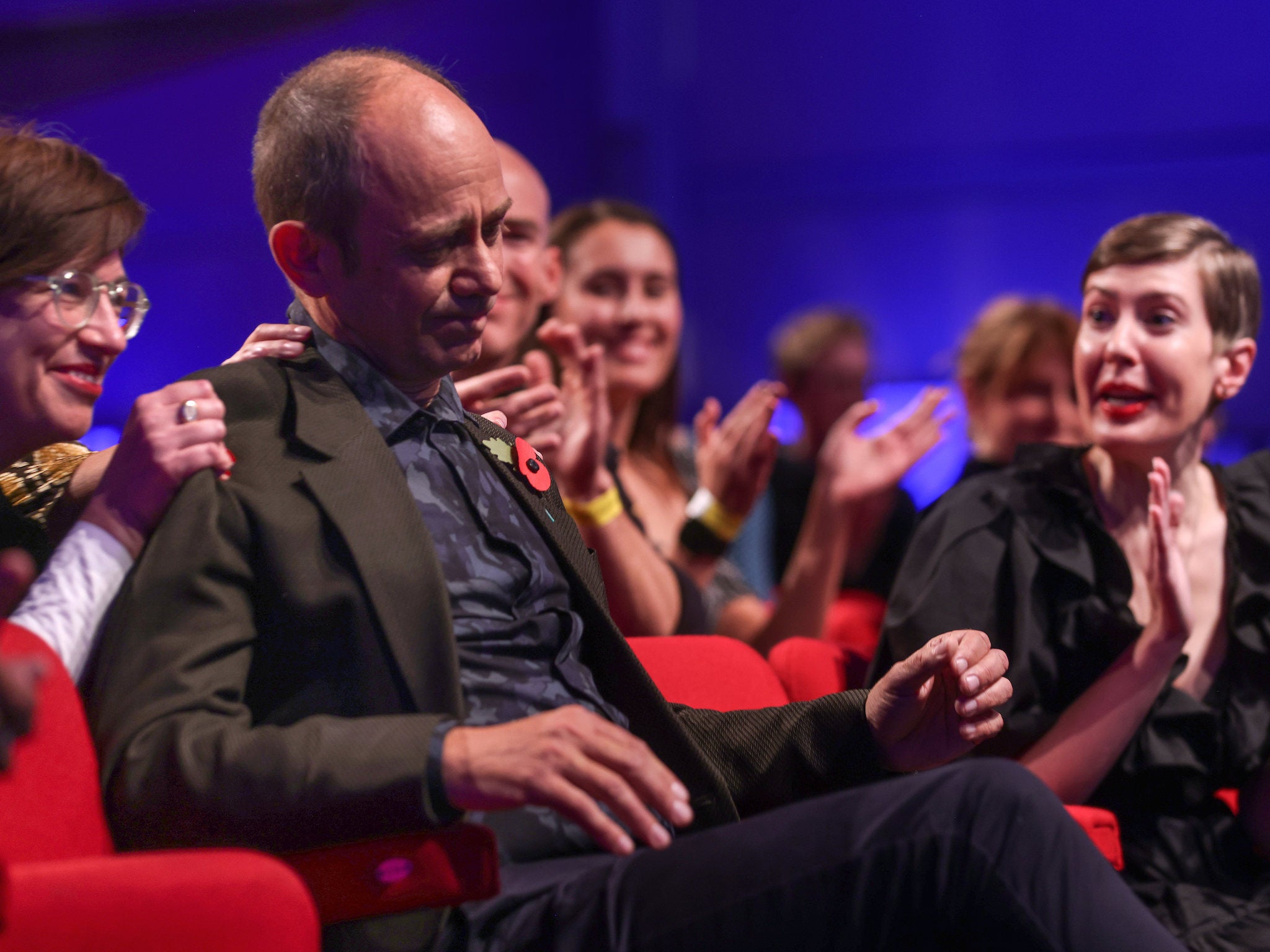 Galgut reacts to the announcement at the 2021 Booker Prize awards ceremony surrounded by fellow nominees