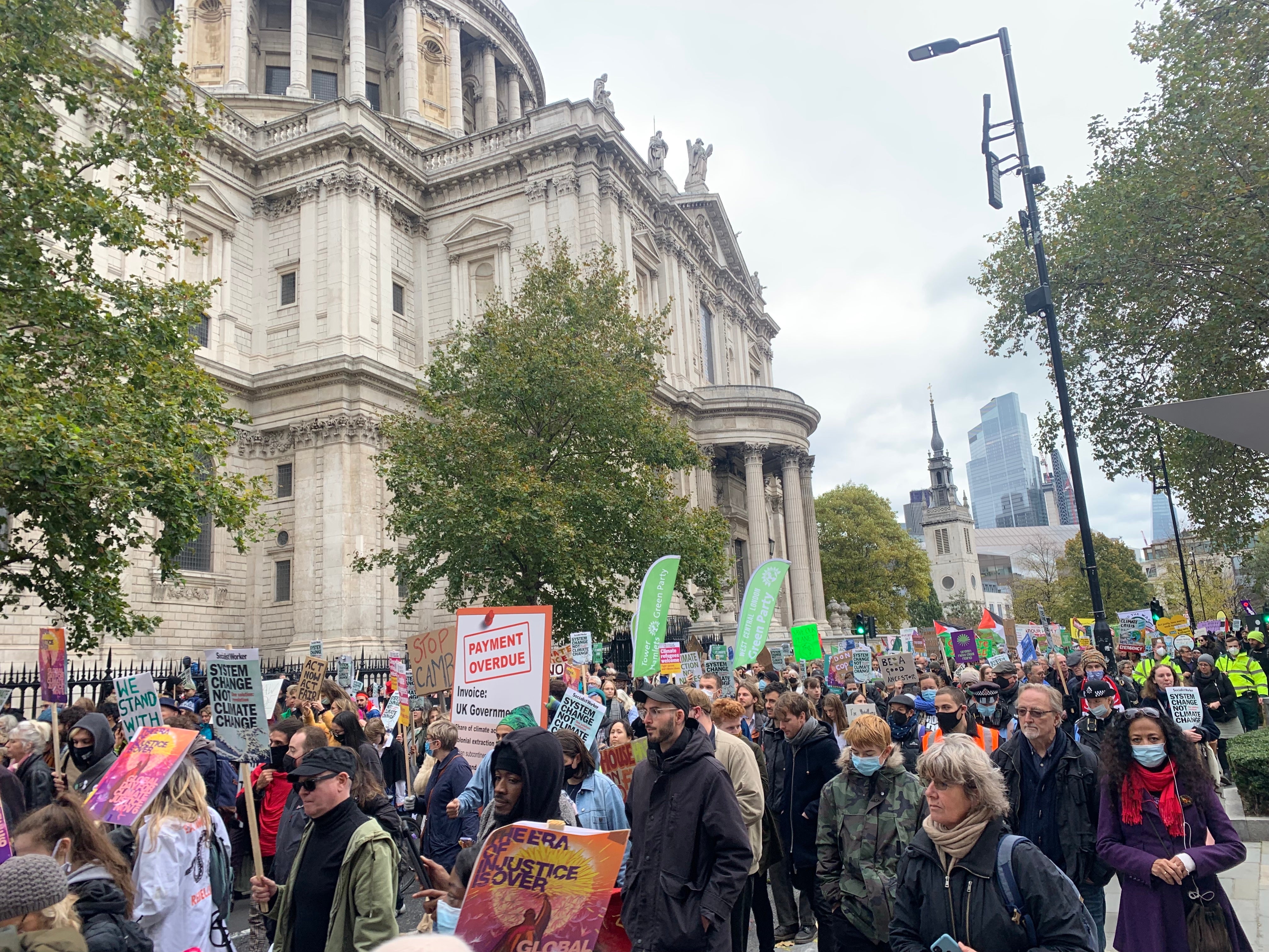 Activists march in front of St Paul’s Cathedral.