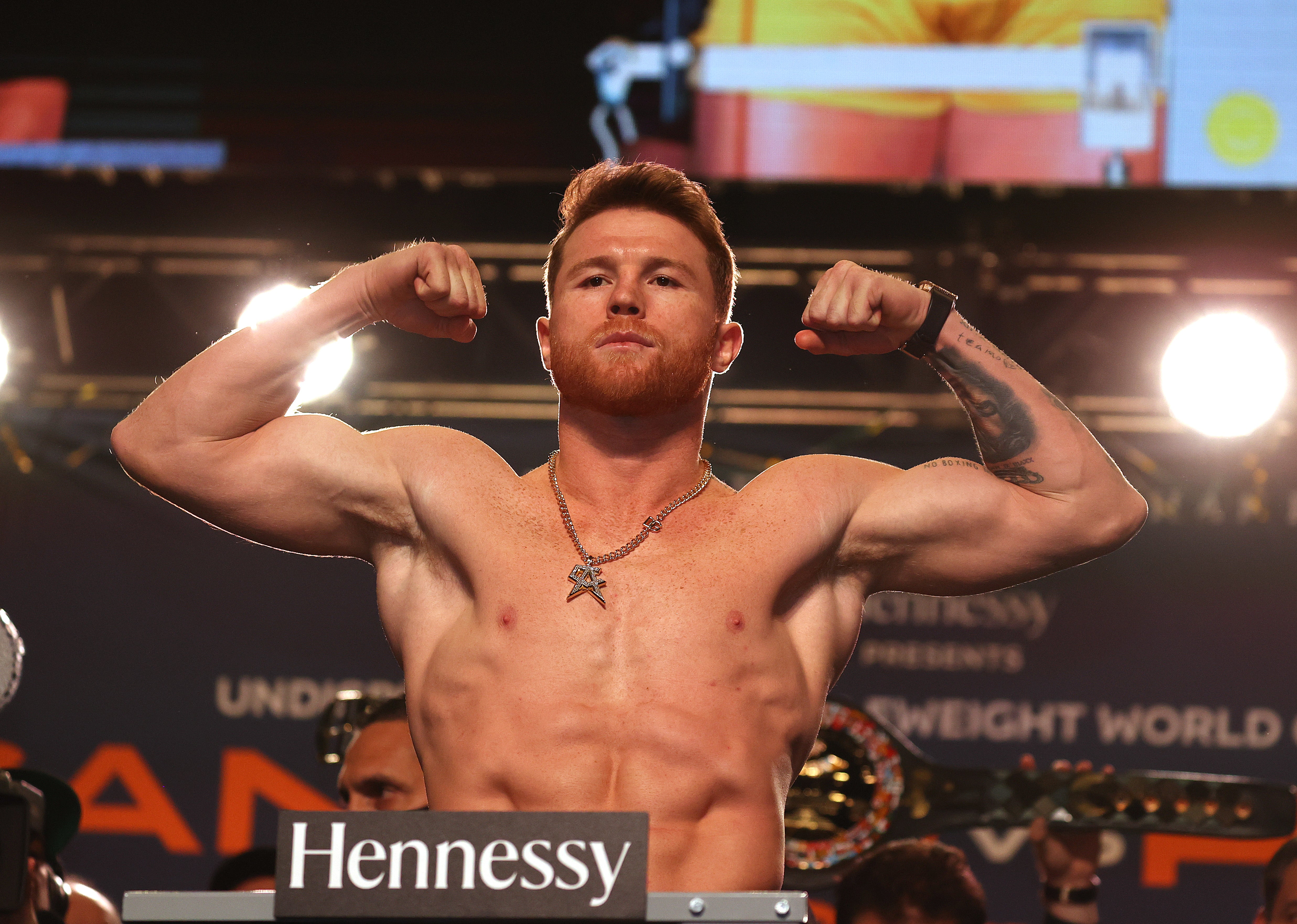 Canelo Alvarez poses on the scale during his official weigh-in at MGM Grand Garden Arena