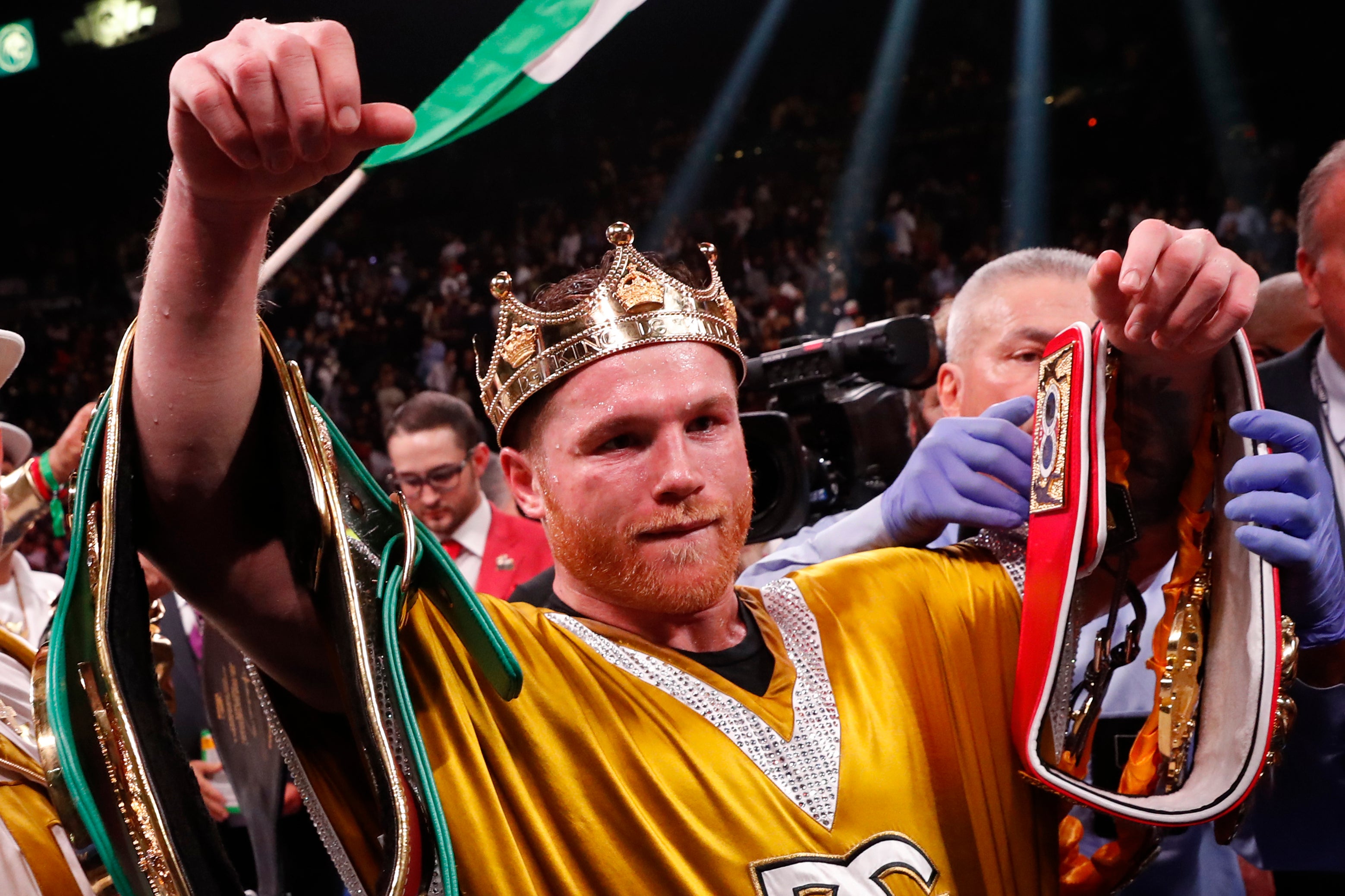 Canelo Alvarez, of Mexico, celebrates after defeating Caleb Plant