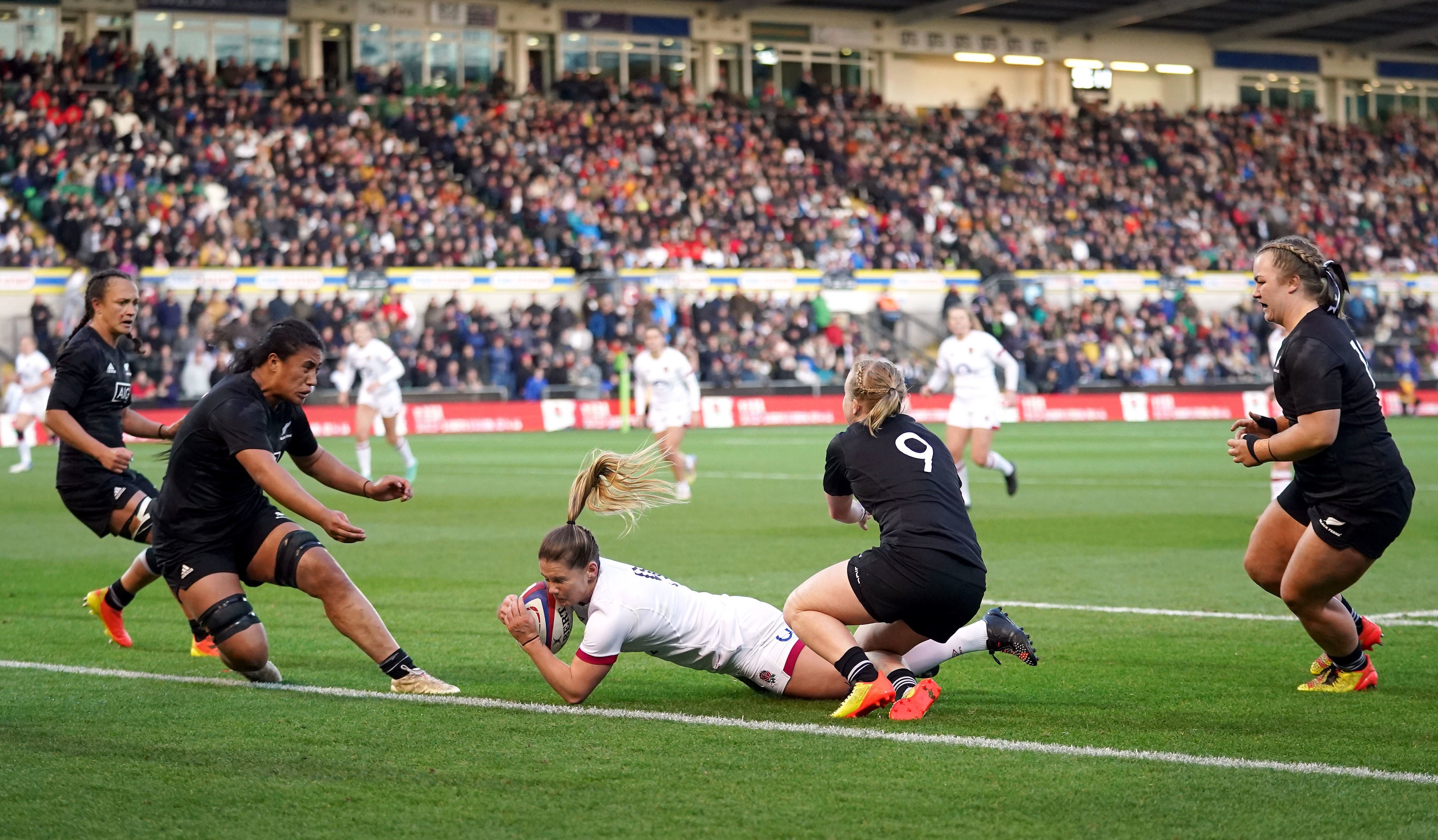 Scrum-half Leanne Infante scores a try against New Zealand
