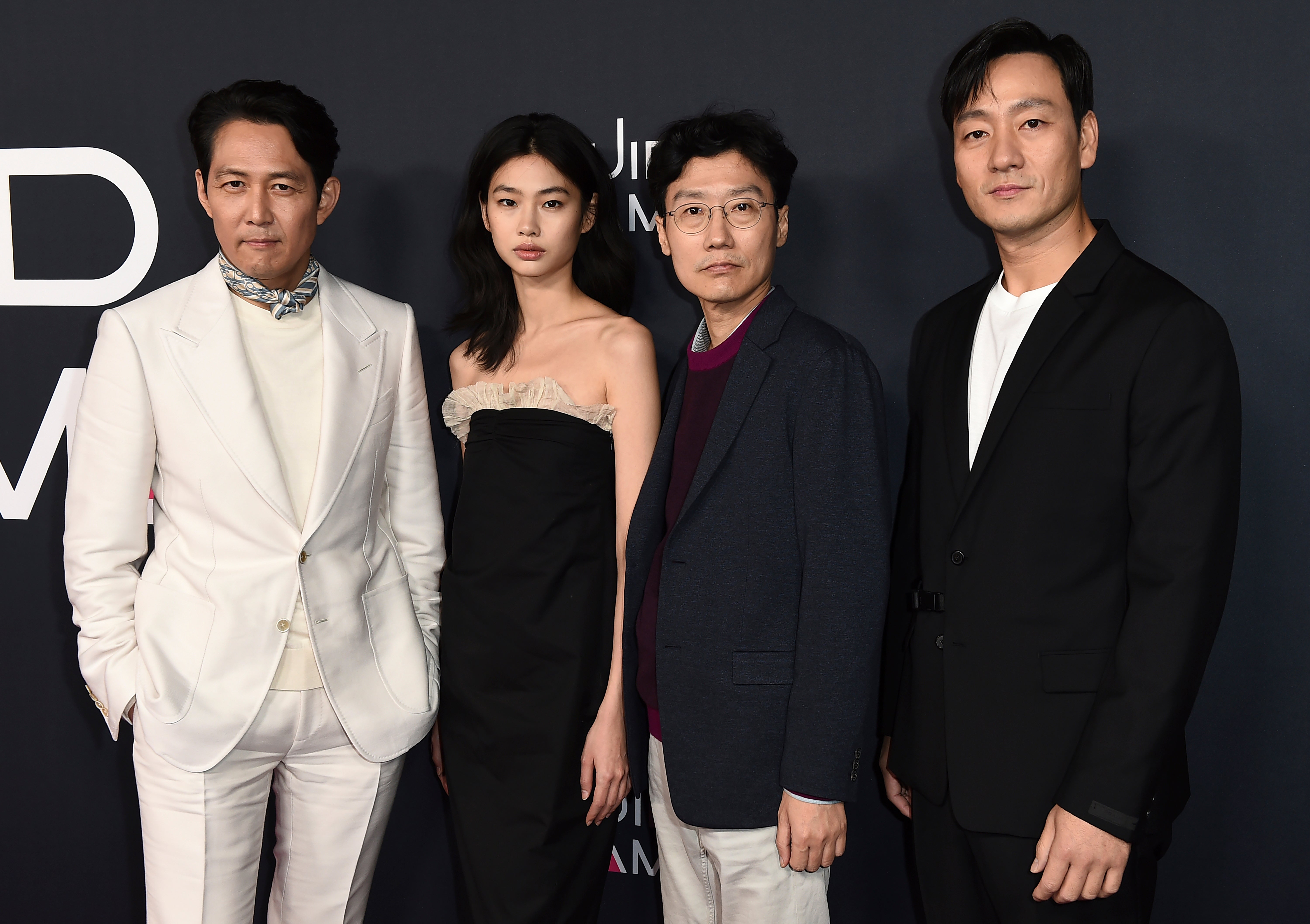 ‘Squid Game’ cast members Lee Jung-jae, Jung Ho-yeon, and Park Hae-Soo, with director Hwang Dong-hyuk at a red carpet event