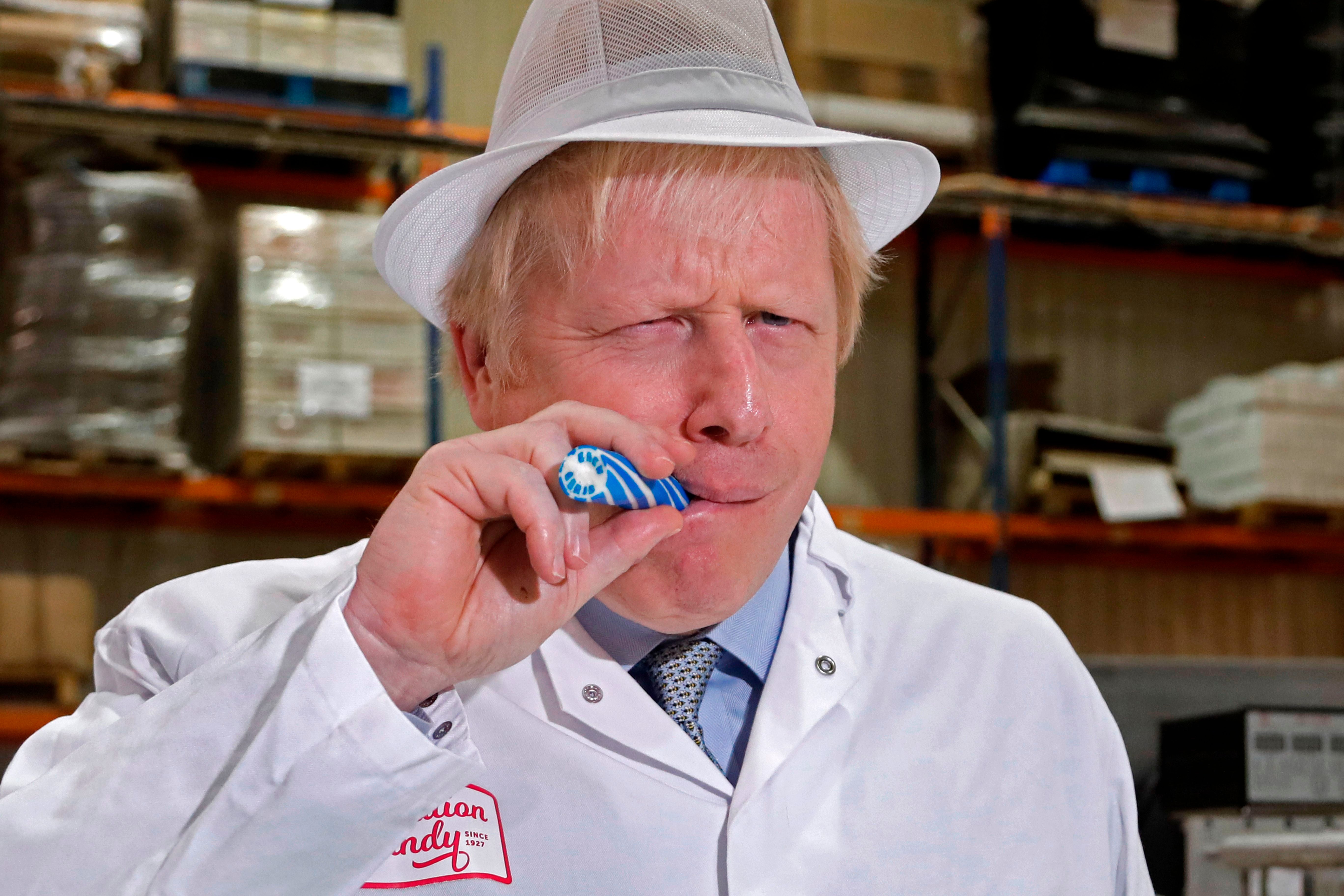 Johnson eats a stick of rock with ‘Back Boris’ running through it