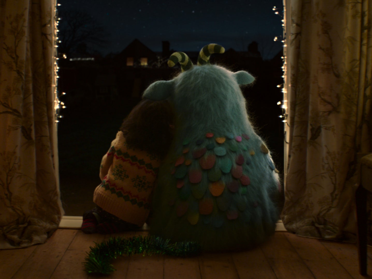Matilda and Iggy sit together while waiting for Santa in McDonald’s 2021 Christmas advert
