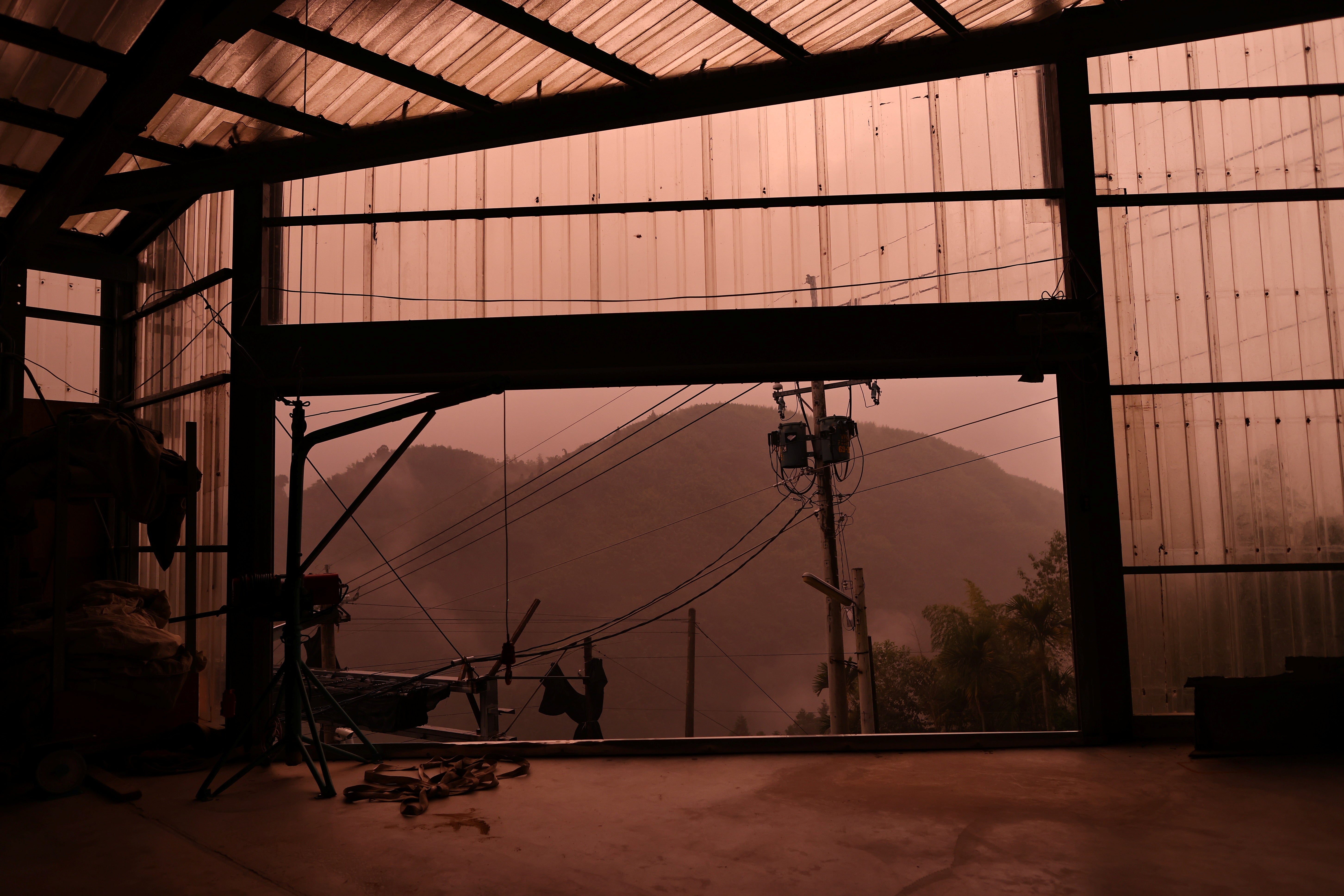 A sudden storm changes the colour of the sky above the tea plantation