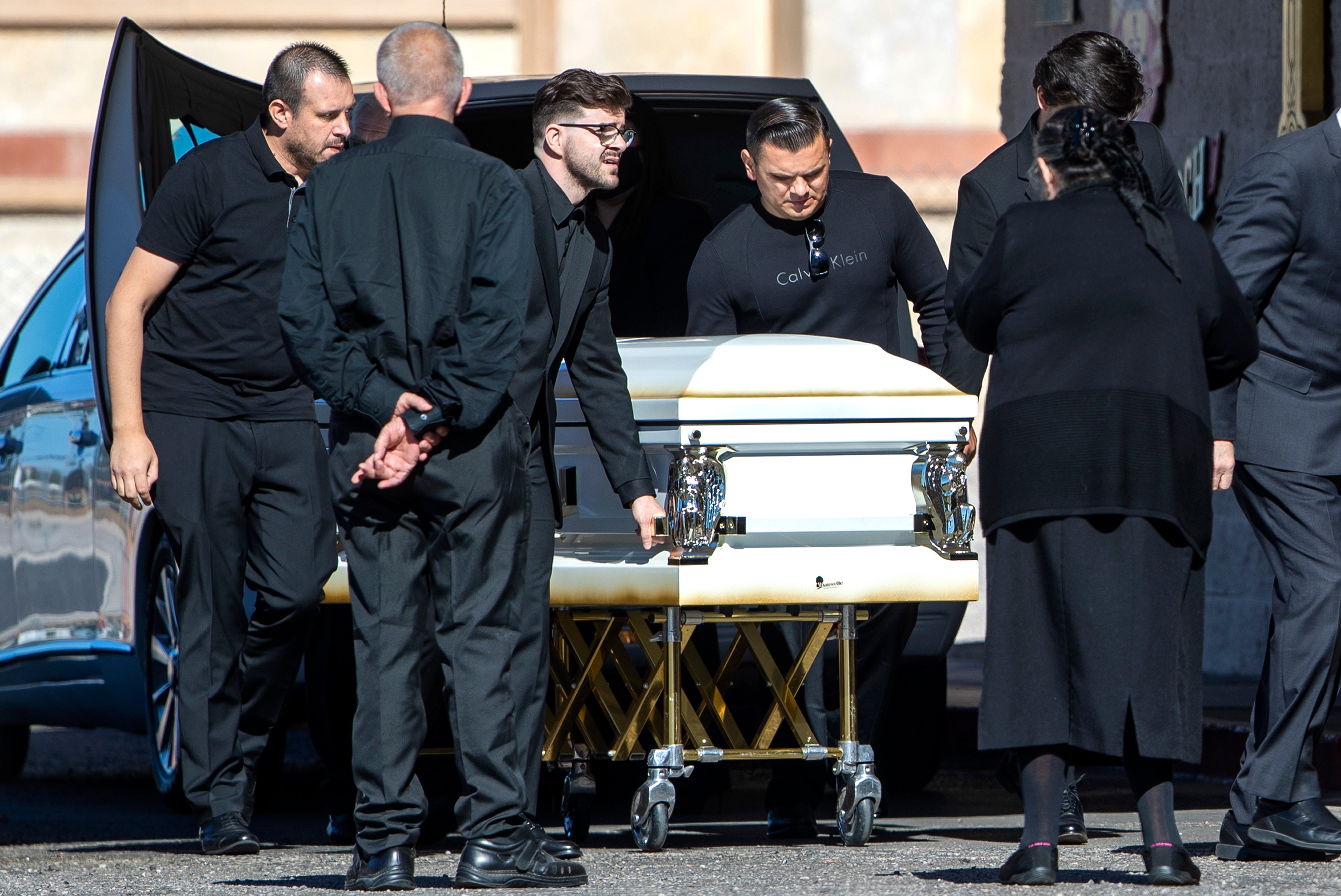 Pallbearers prepare to bring in the casket of Tina Tintor before a memorial at St. Simeon Serbian Orthodox Church in Las Vegas Thursday, Nov. 11, 2021. Tintor, 23, was killed in a fiery crash involving former Las Vegas Raiders wide receiver Henry Ruggs III Nov. 2, in Las Vegas.