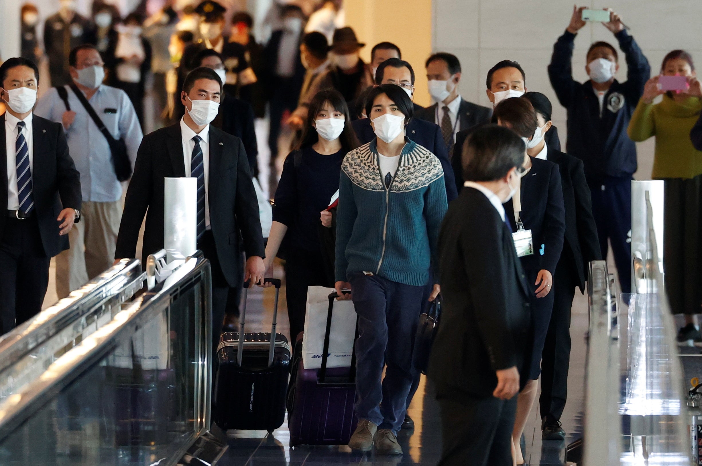 Mako Komuro and her newly married husband Kei arrive before they board a flight bound for New York to start their new life in the US