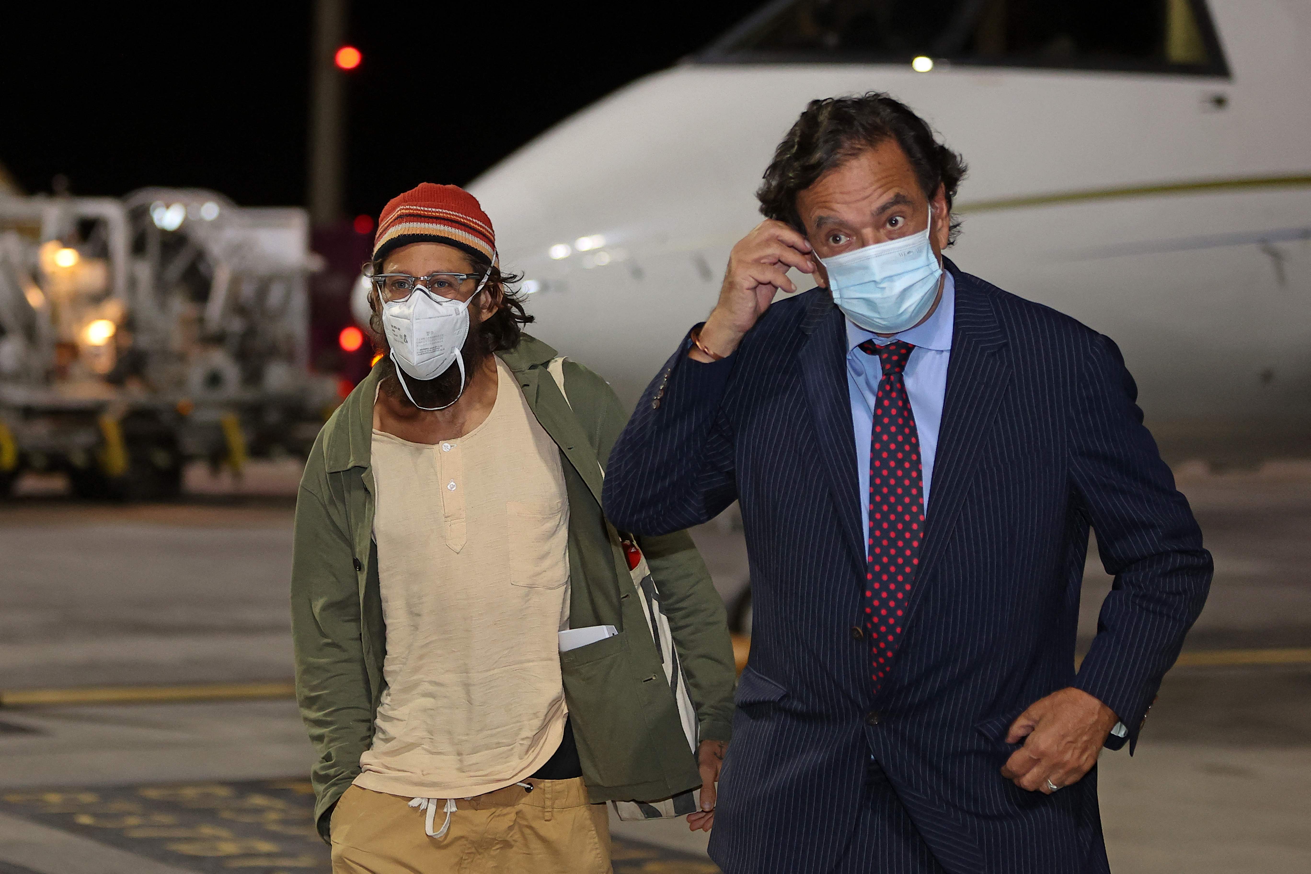 US journalist Danny Fenster and diplomat Bill Richardson leave a plane in Doha, Qatar