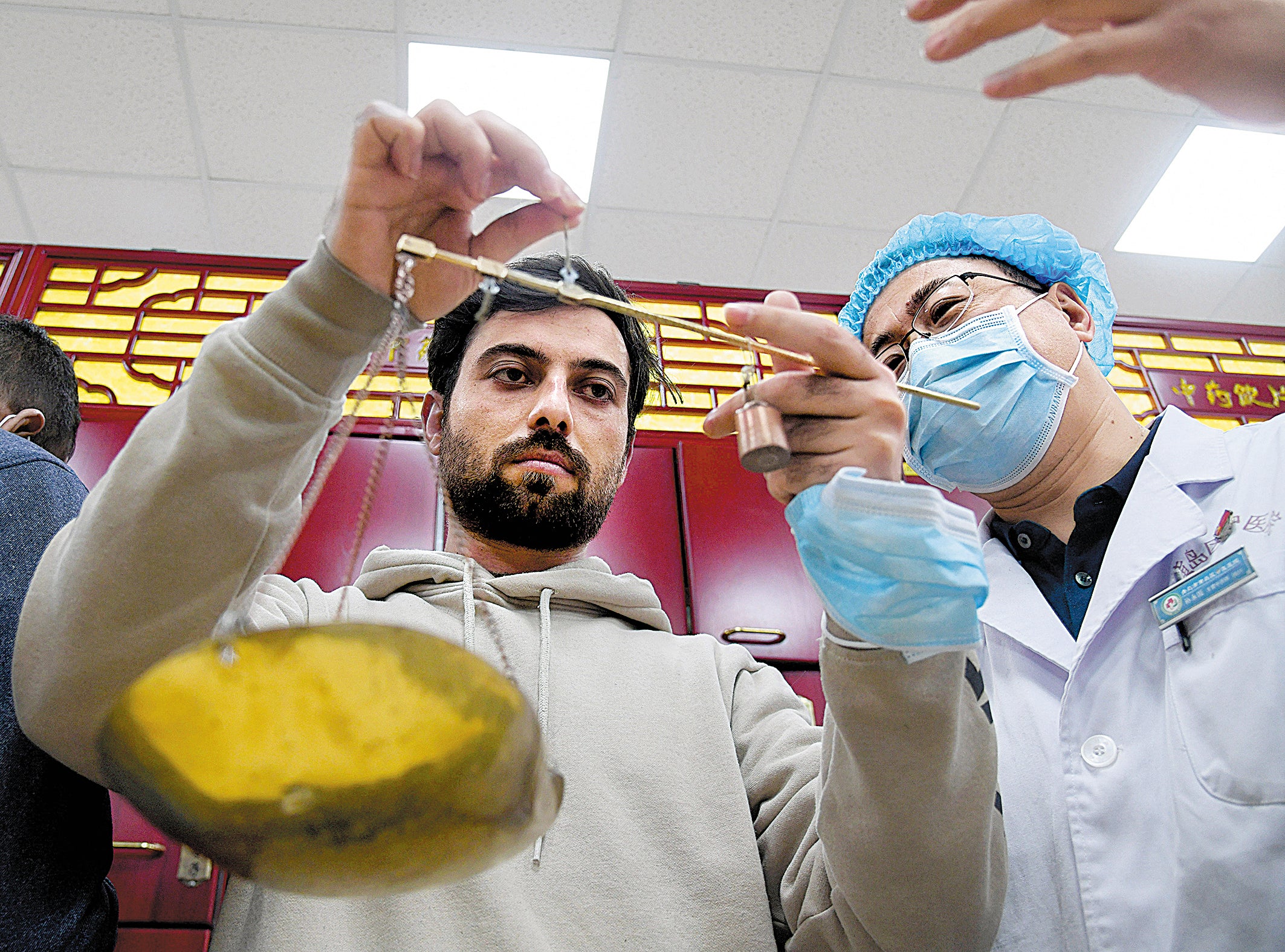 A student at a training centre in Qingdao, Shandong province, learns how to weigh raw materials used in Traditional Chinese Medicine