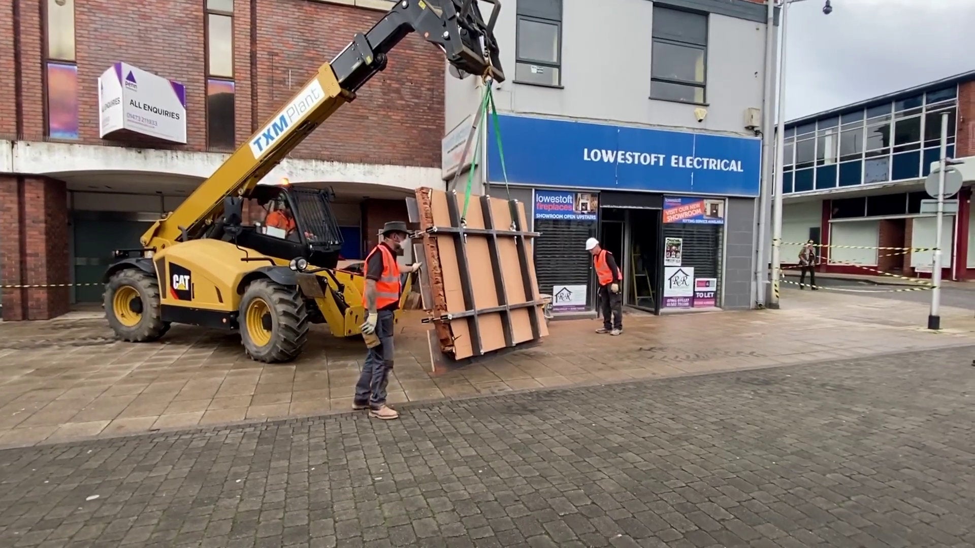 The wall was removed via a yellow telehandler