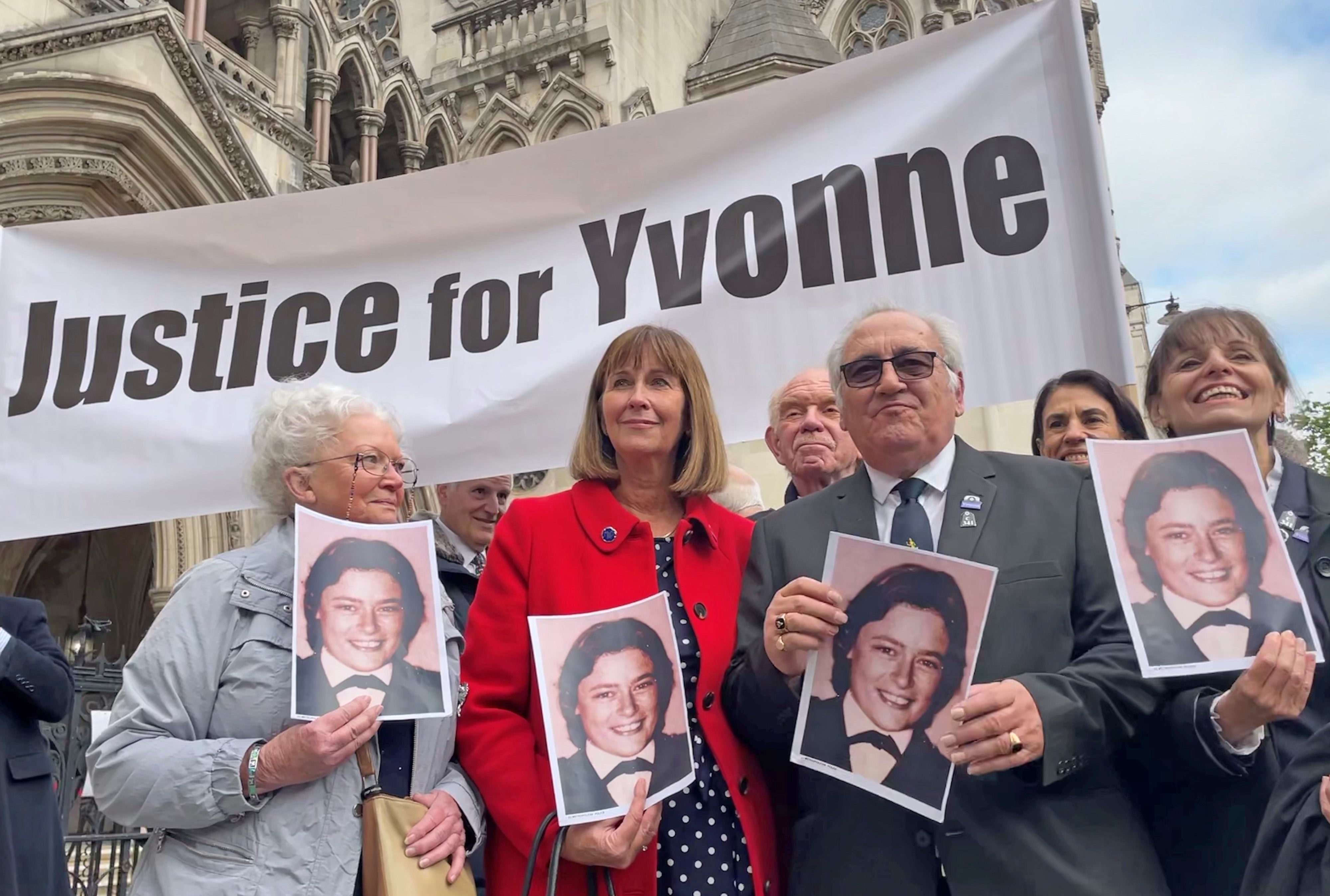 Retired police officer John Murray (second right) outside the Royal Courts of Justice in London on Tuesday