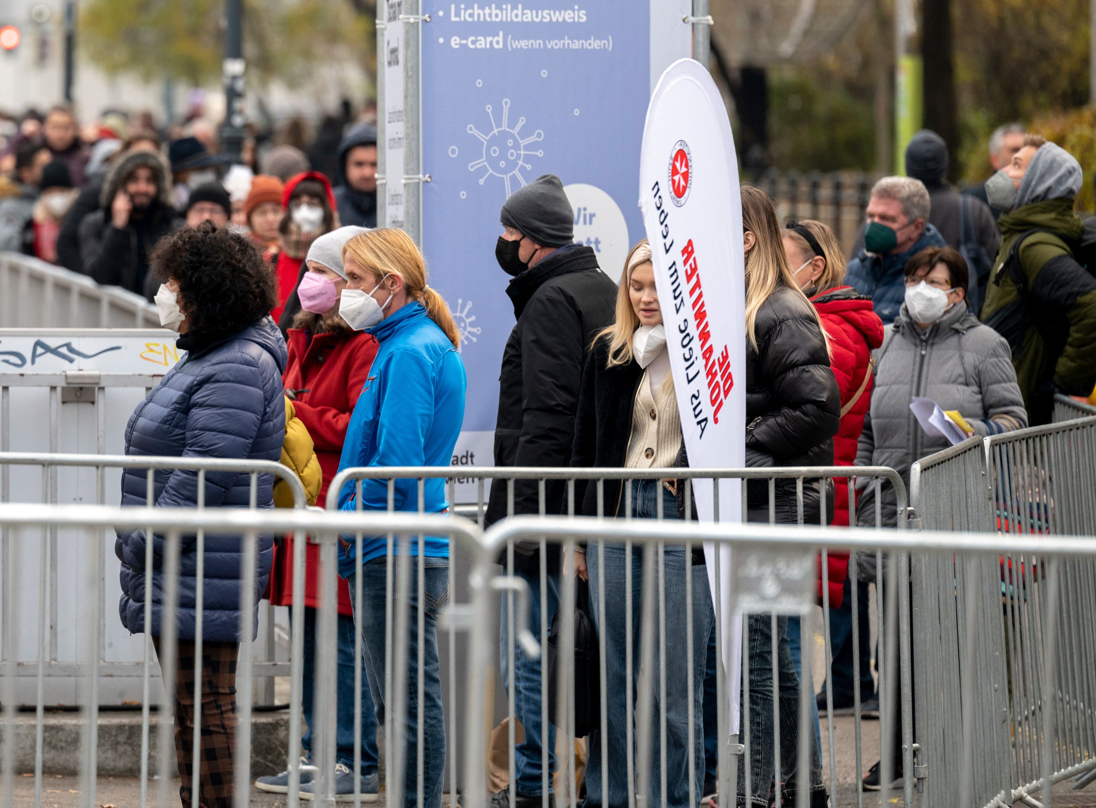 People queue for a vaccine in Vienna the day after partial lockdown was imposed