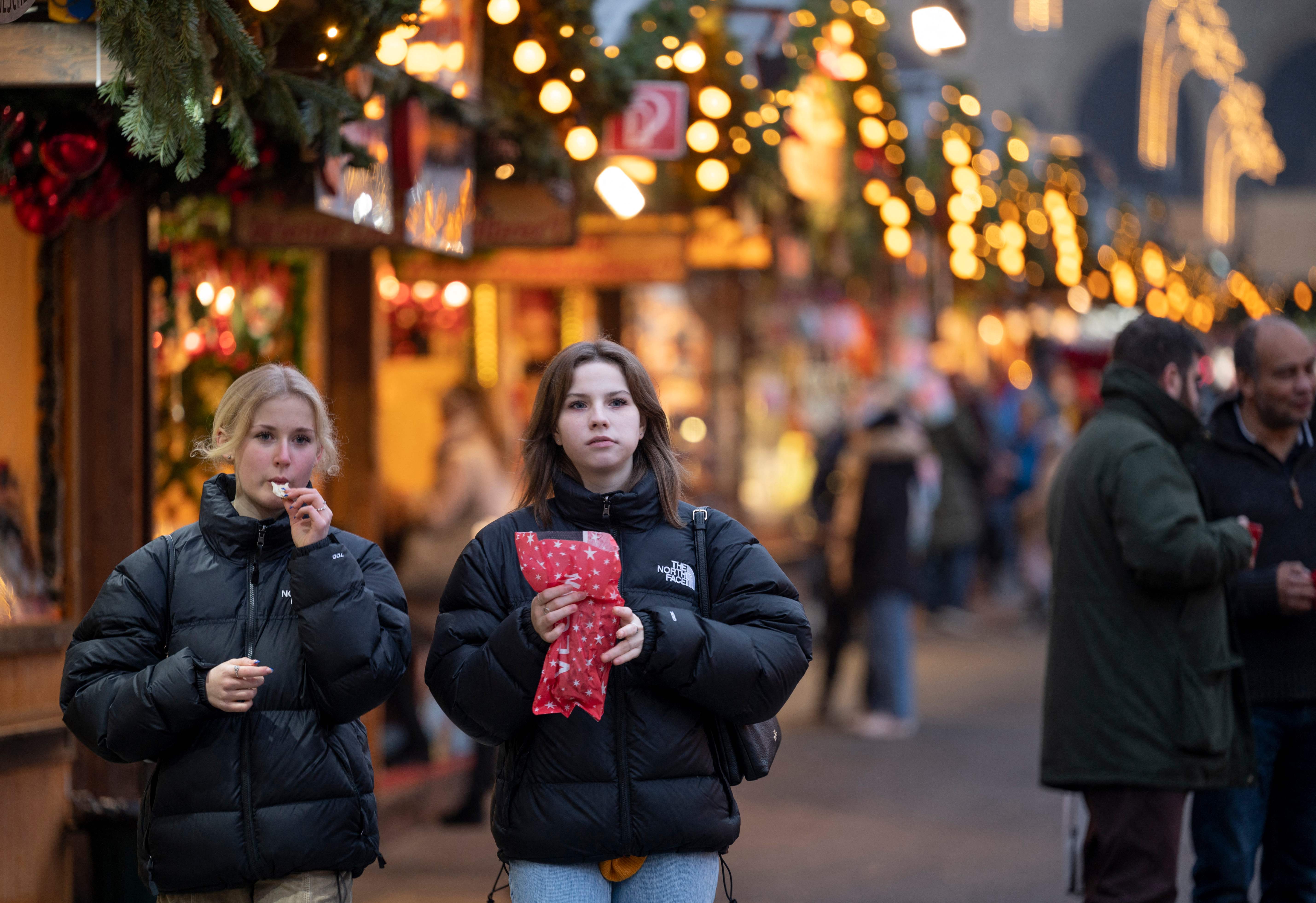 People enjoy their snacks at the traditional annual Christmas Market in Vienna