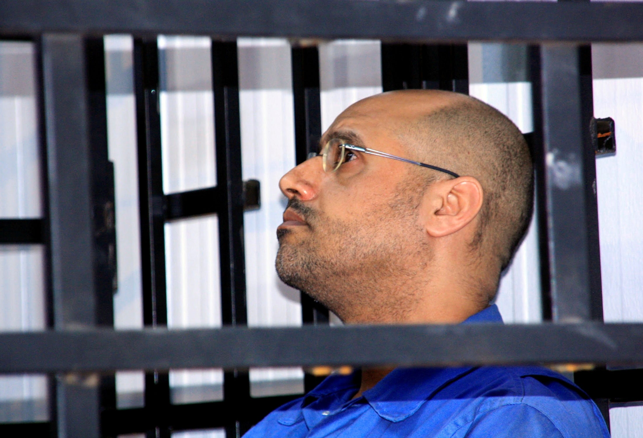 Saif al-Islam Gaddafi attends a hearing in a courtroom in Zintan in 2014