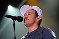 Will Young handcuffs himself to dog breeding centre at protest