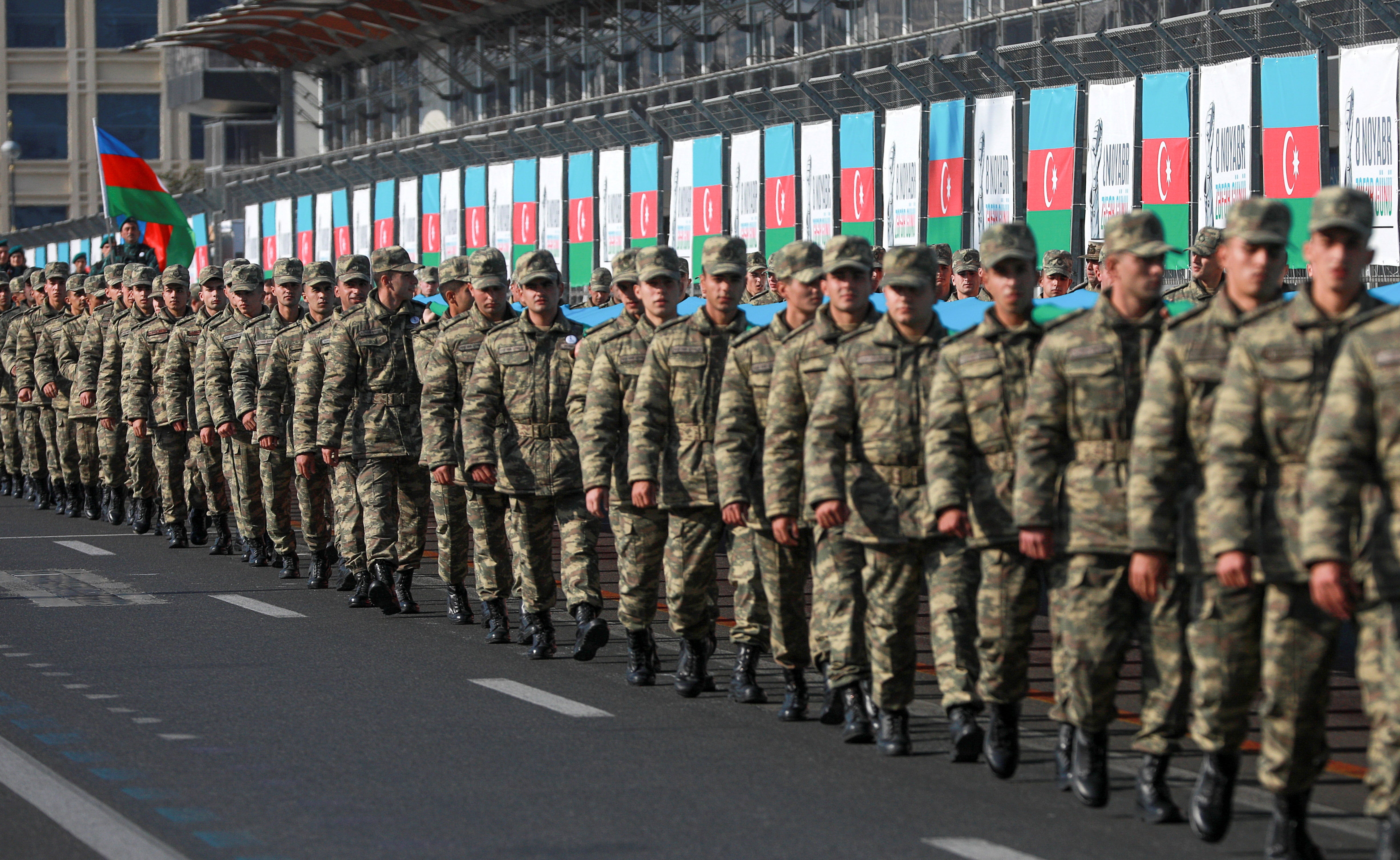 Azeri service members mark the anniversary of the end of the 2020 military conflict over Nagorno-Karabakh