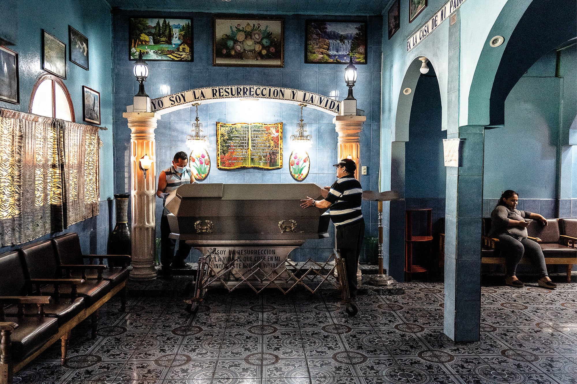 Miguel Angel (left) and Cesar Barrio (centre), prepare the coffin for the wake of a 37-year-old man who was killed in a motorcycle drive-by shooting in Colonia Santa Cristina, Barrio Santa Anita, San Salvador