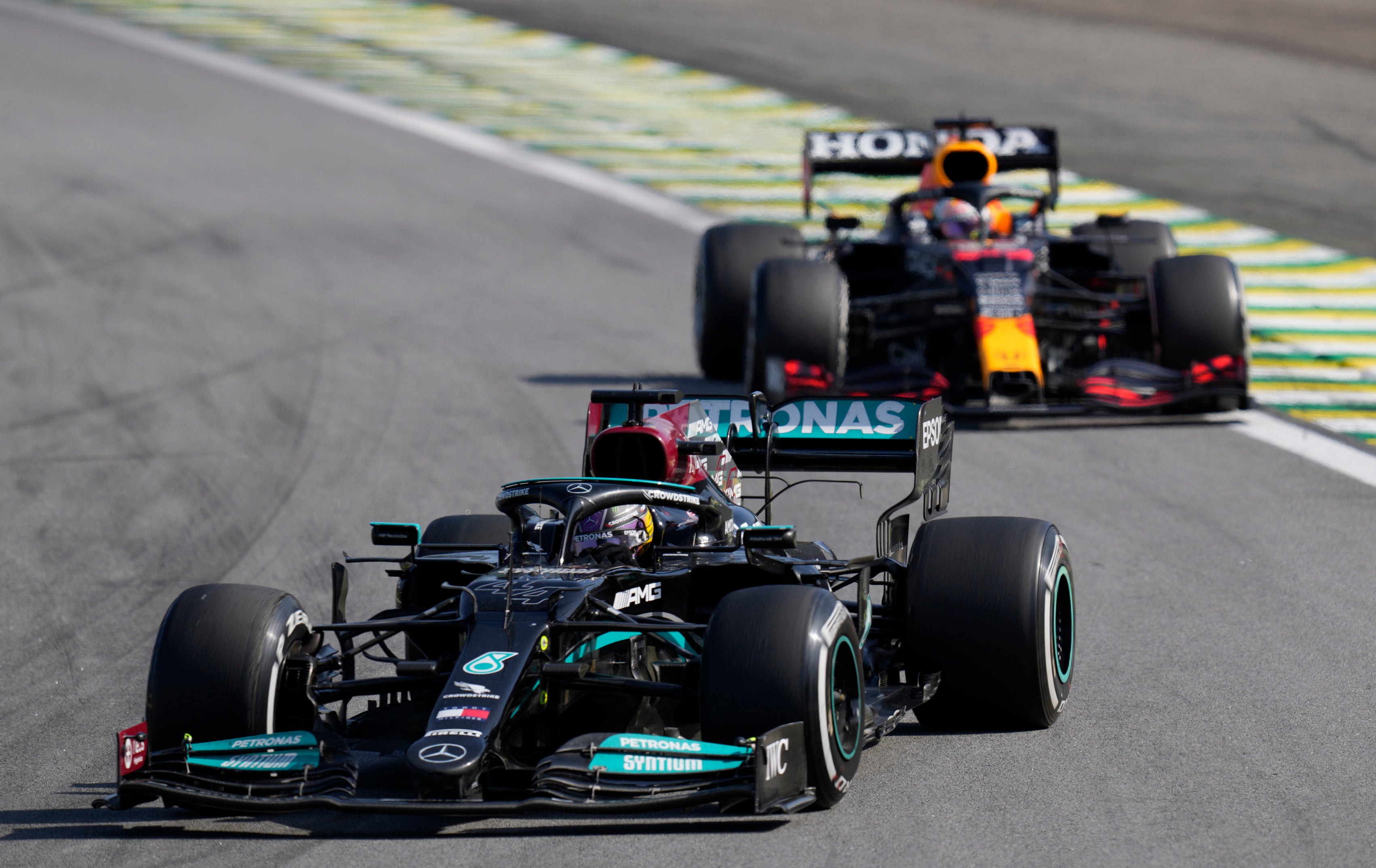 Lewis Hamilton, front, was able to pass Max Verstappen later in the race after they clashed at Interlagos (Andre Penner/AP)