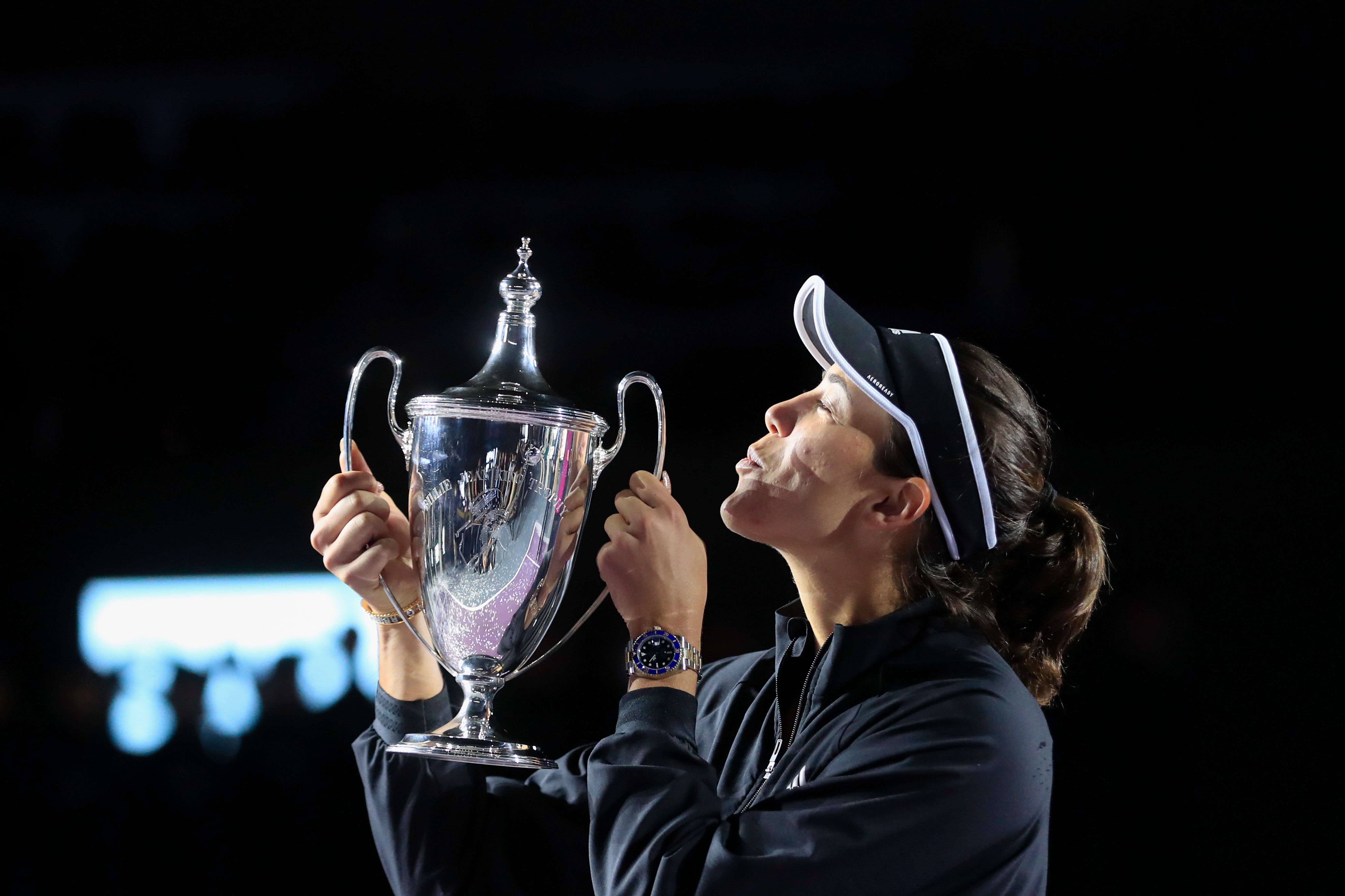 Garbine Muguruza kisses the trophy during an awarding ceremony after defeating Anett Kontaveit, of Estonia, at the final match of the WTA Finals tennis tournament in Guadalajara, Mexico (Refugio Ruiz/AP)