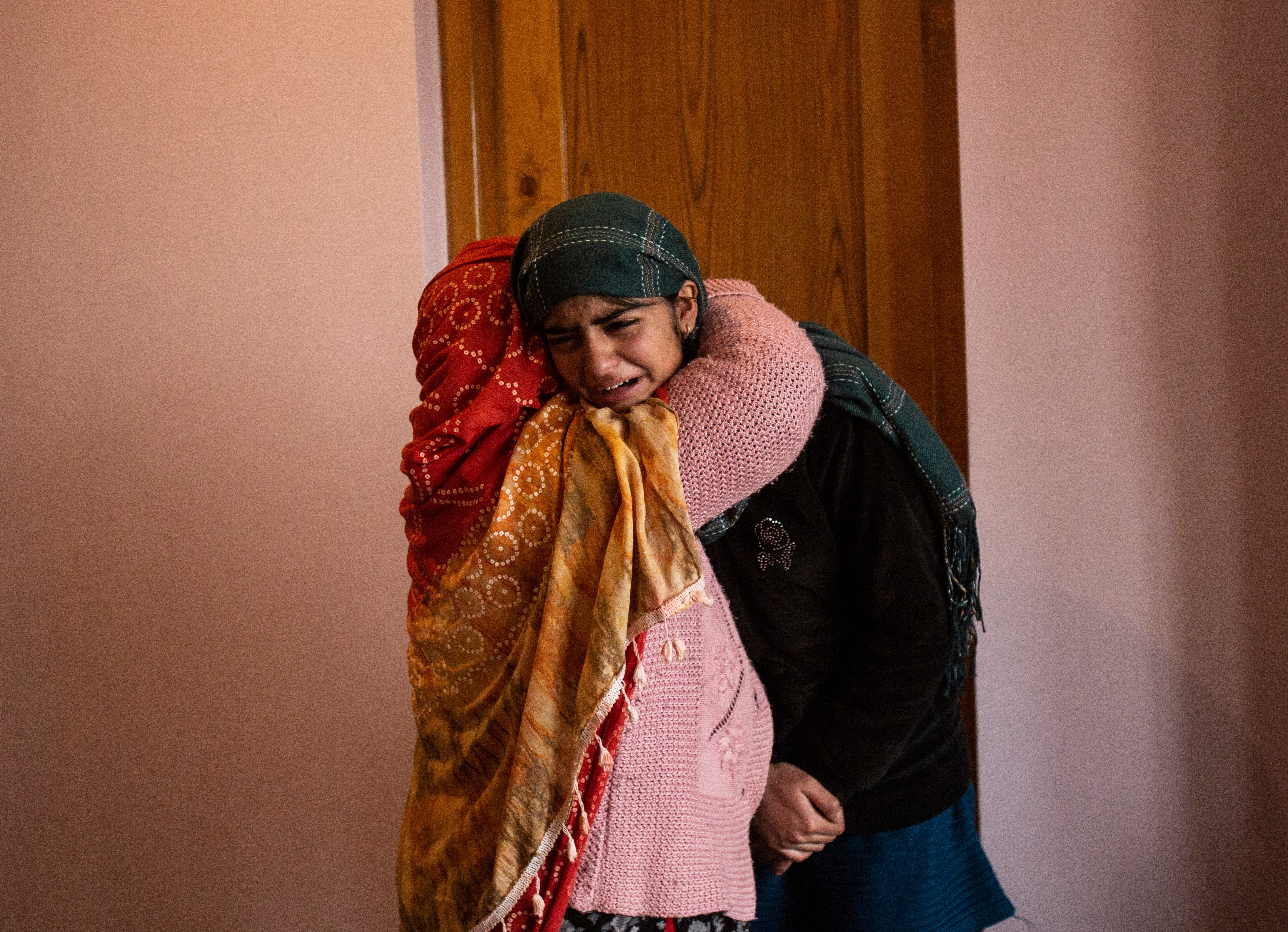 Teenage daughter of Mohammad Altaf Bhat weeps after her father was killed in Srinagar on 15 November by security forces along with three others