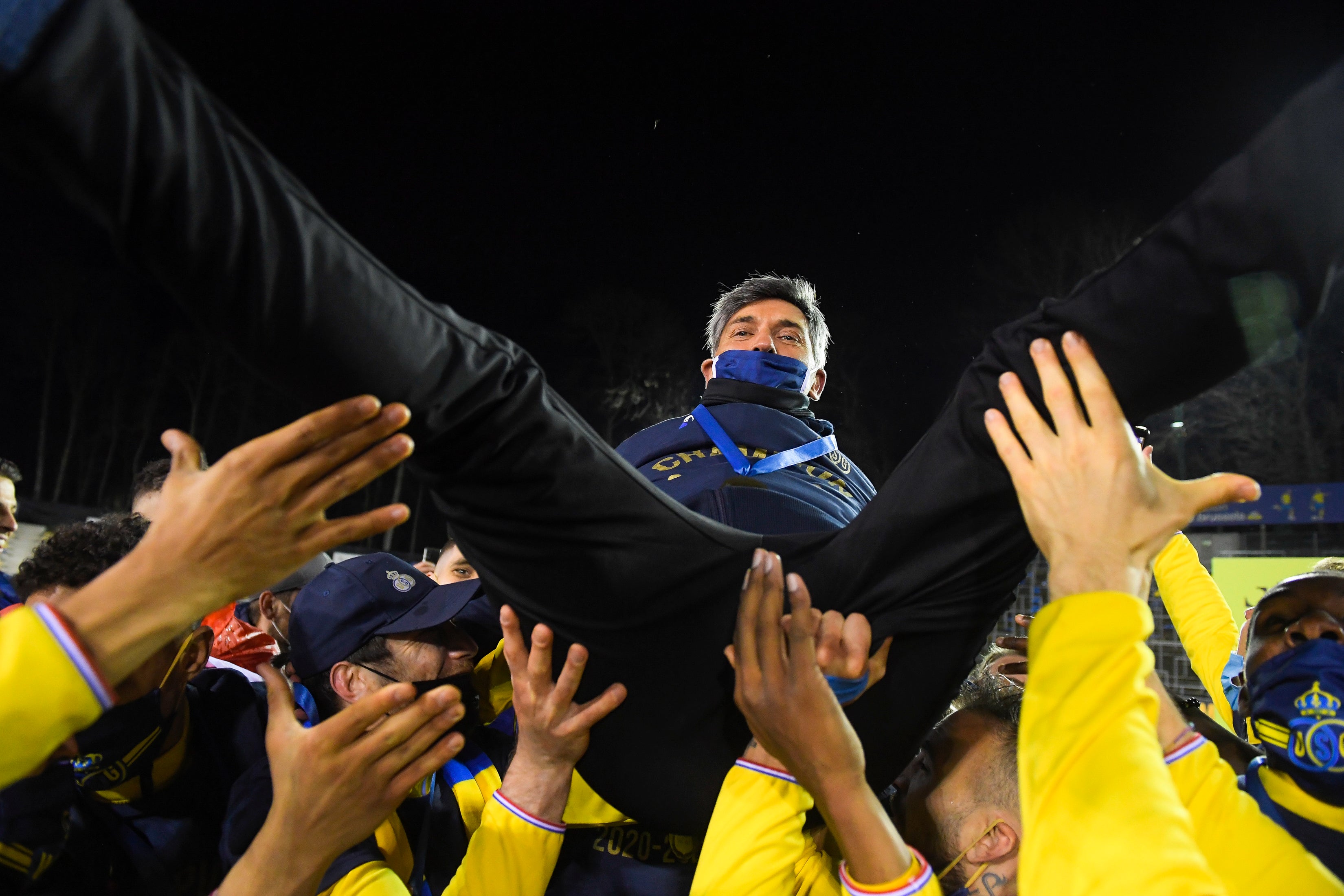 Union’s players lift manager Felice Mazzu after sealing promotion to the top flight