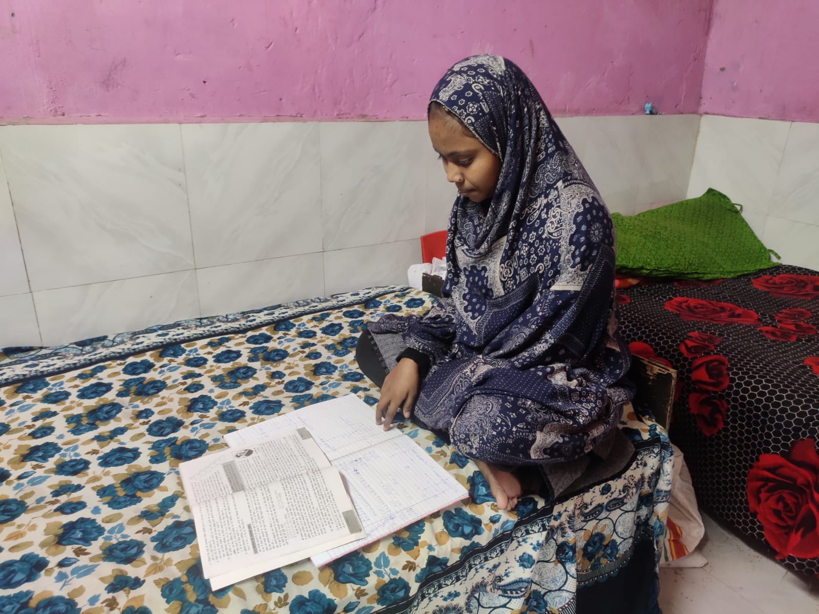 Arzina Khatun, 16, studying in her room in South Delhi