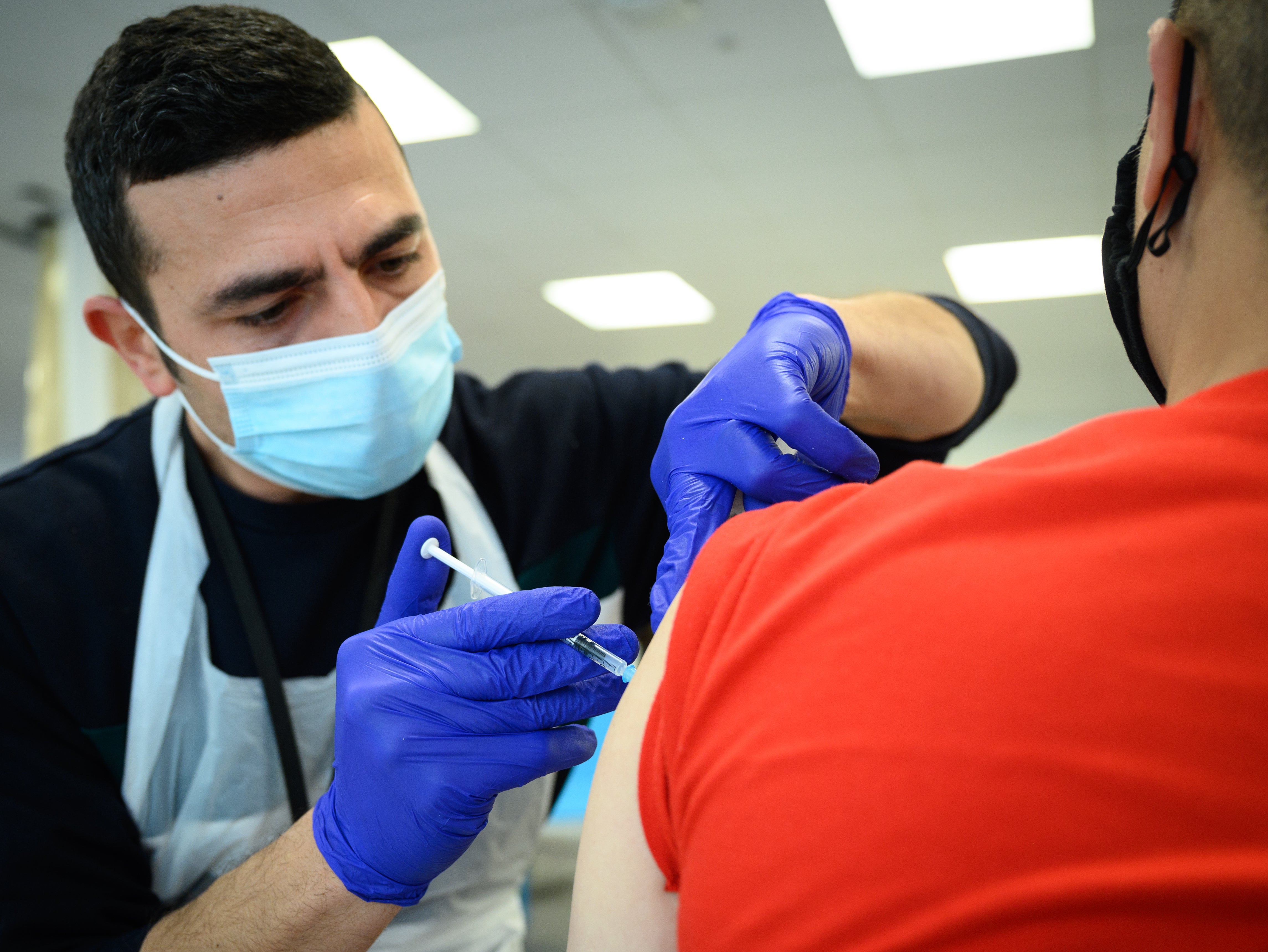 A man receives his Covid booster jab in Stratford, London