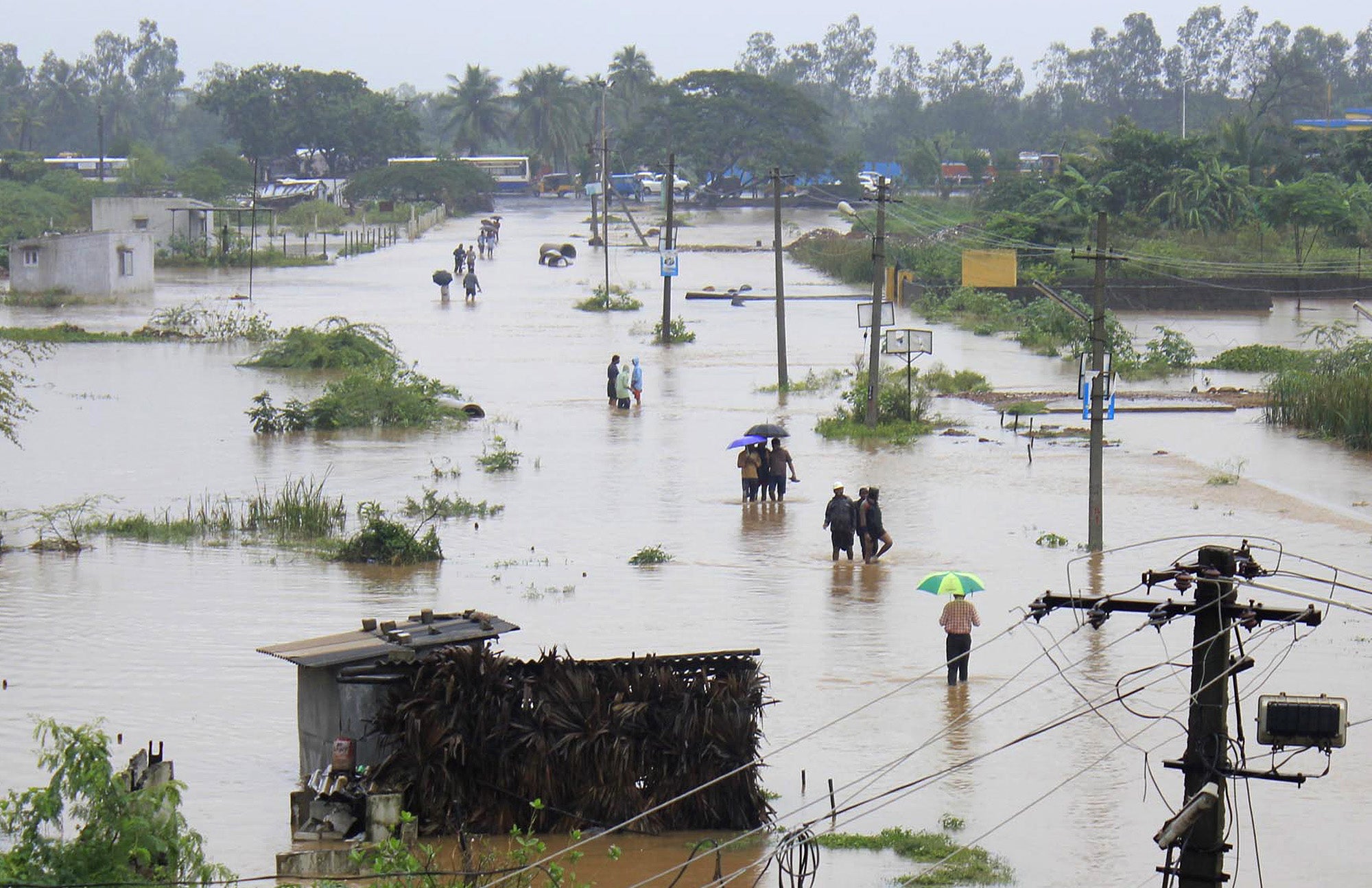 File: Indian residents wade through flood waters in Visakhapatnam in the coastal district of Andhra Pradesh on November 5, 2012