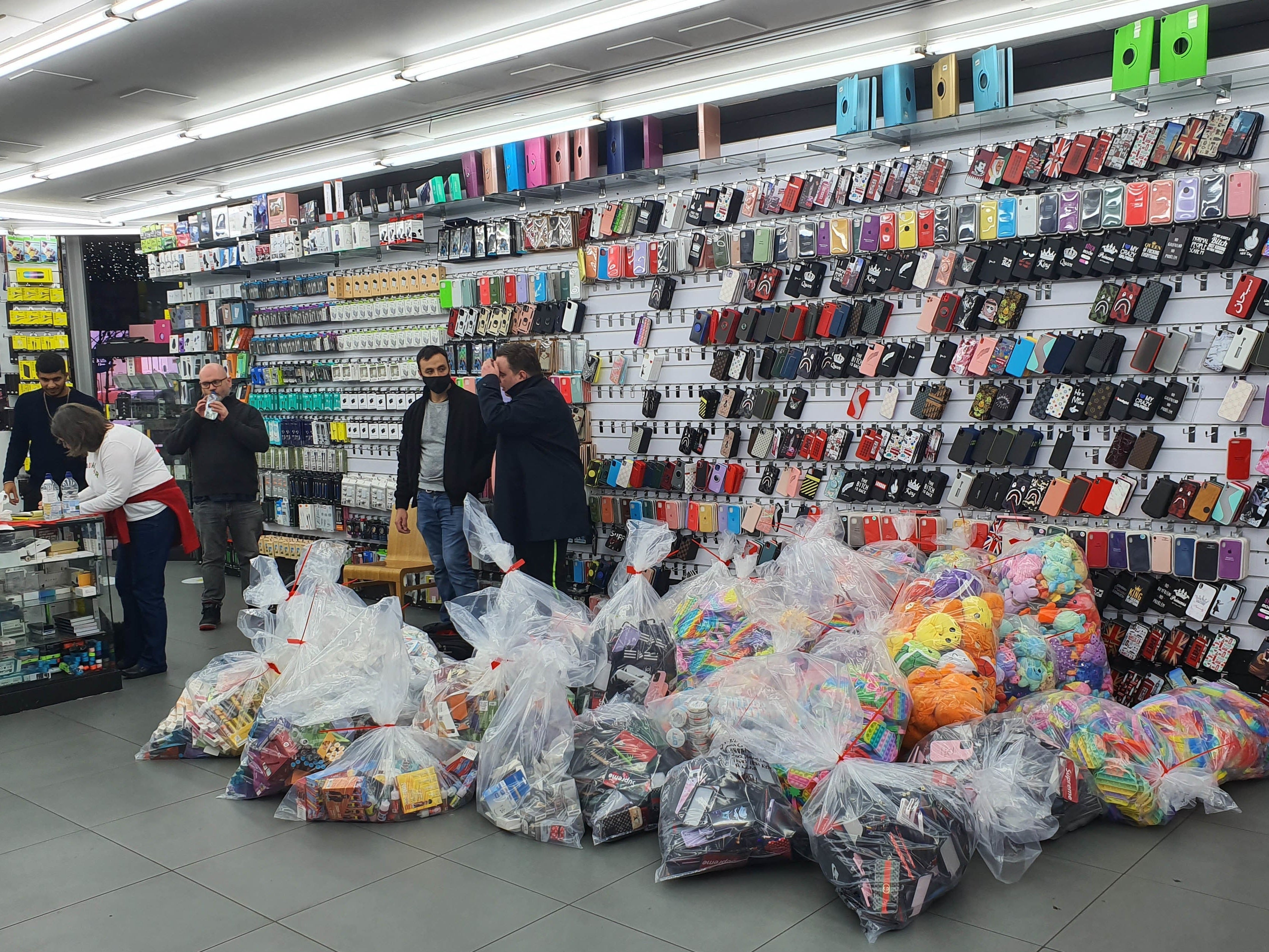 Goods are seized by during a raid on a store on Oxford Street in London’s West End