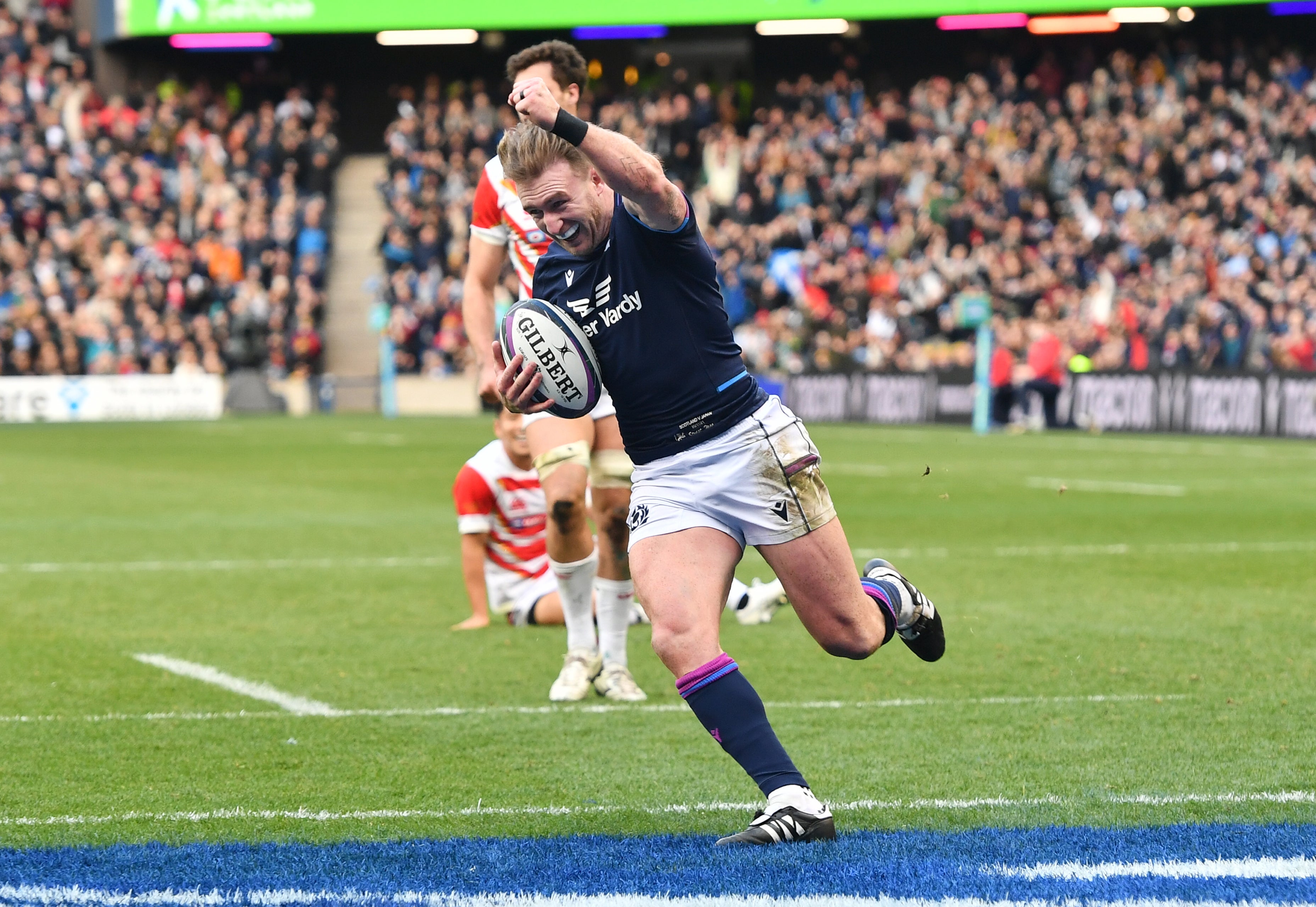 Scotland’s Stuart Hogg celebrates before scoring his record-breaking try (Malcolm Mackenzie/PA)